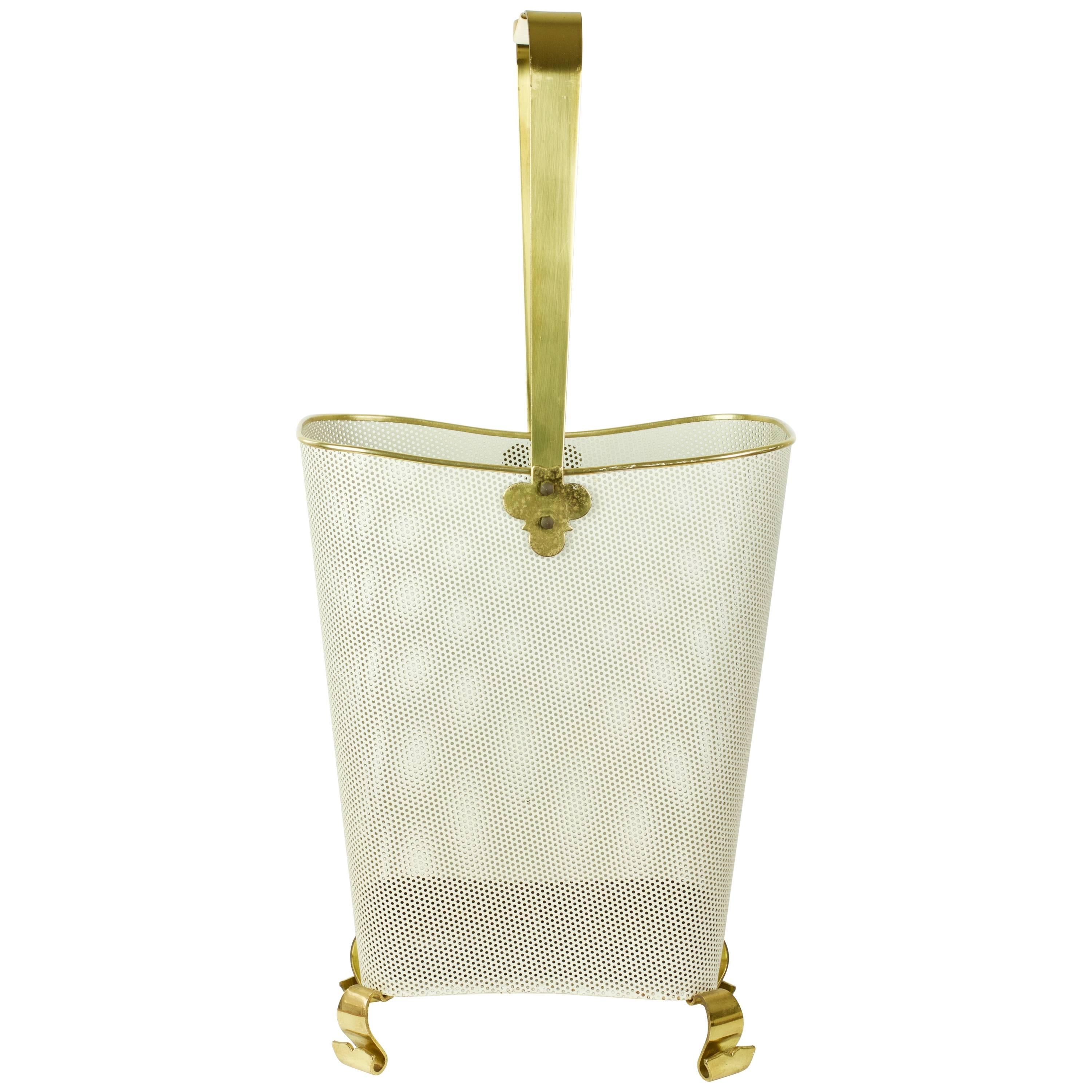 Mathieu Matégot style mid-century umbrella stand mad of white perforated metal basket and the beautifully crafted curved solid polished brass feet and delicate handle finals give the piece a unique and luxurious feel and are very reminiscent of work