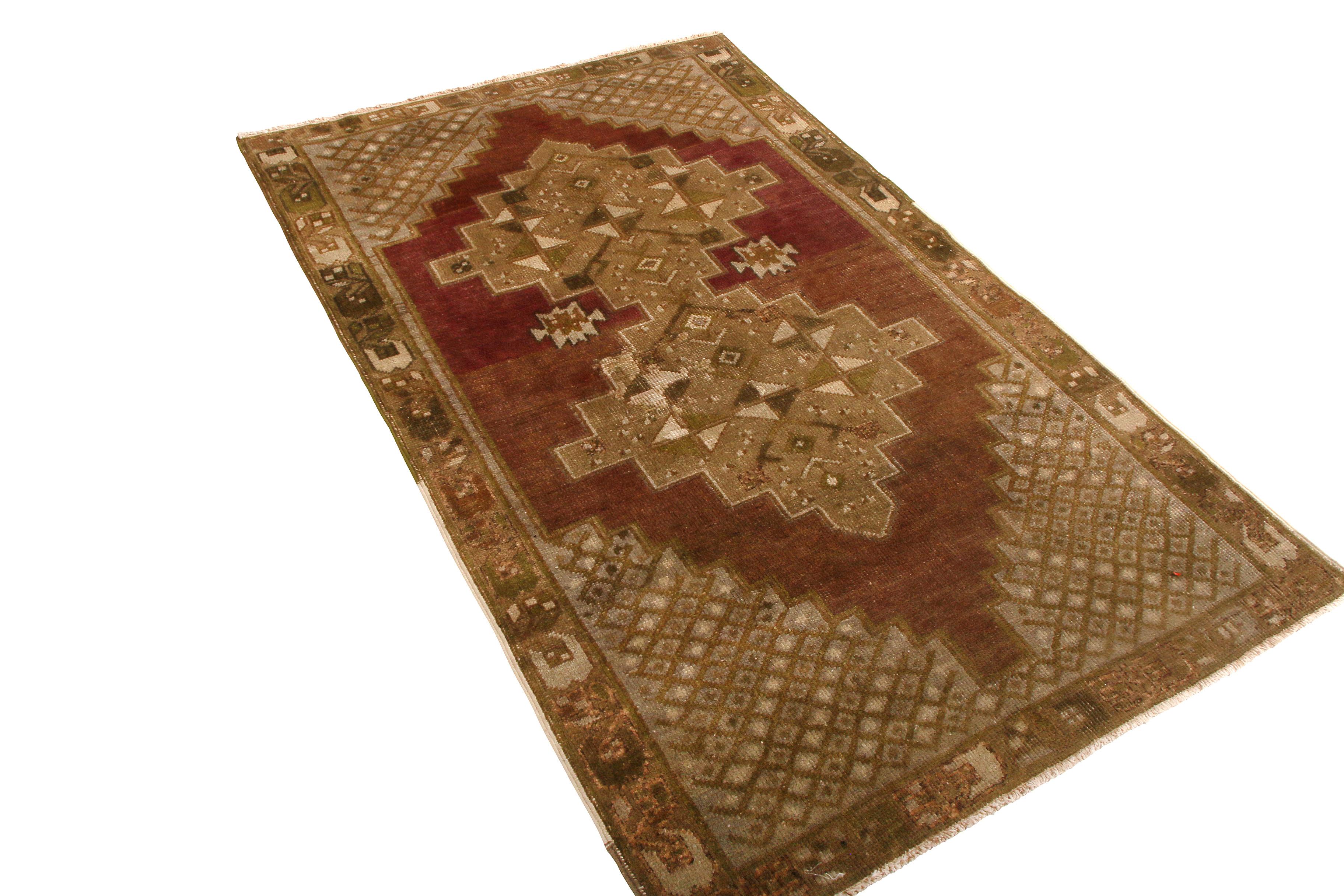 Hand knotted in Turkey originating between 1950-1960, this vintage midcentury Oushak rug enjoys the marriage of both Classic elements and uncommon, rich colorway variation in the field behind the traditional medallion pattern. The split between the