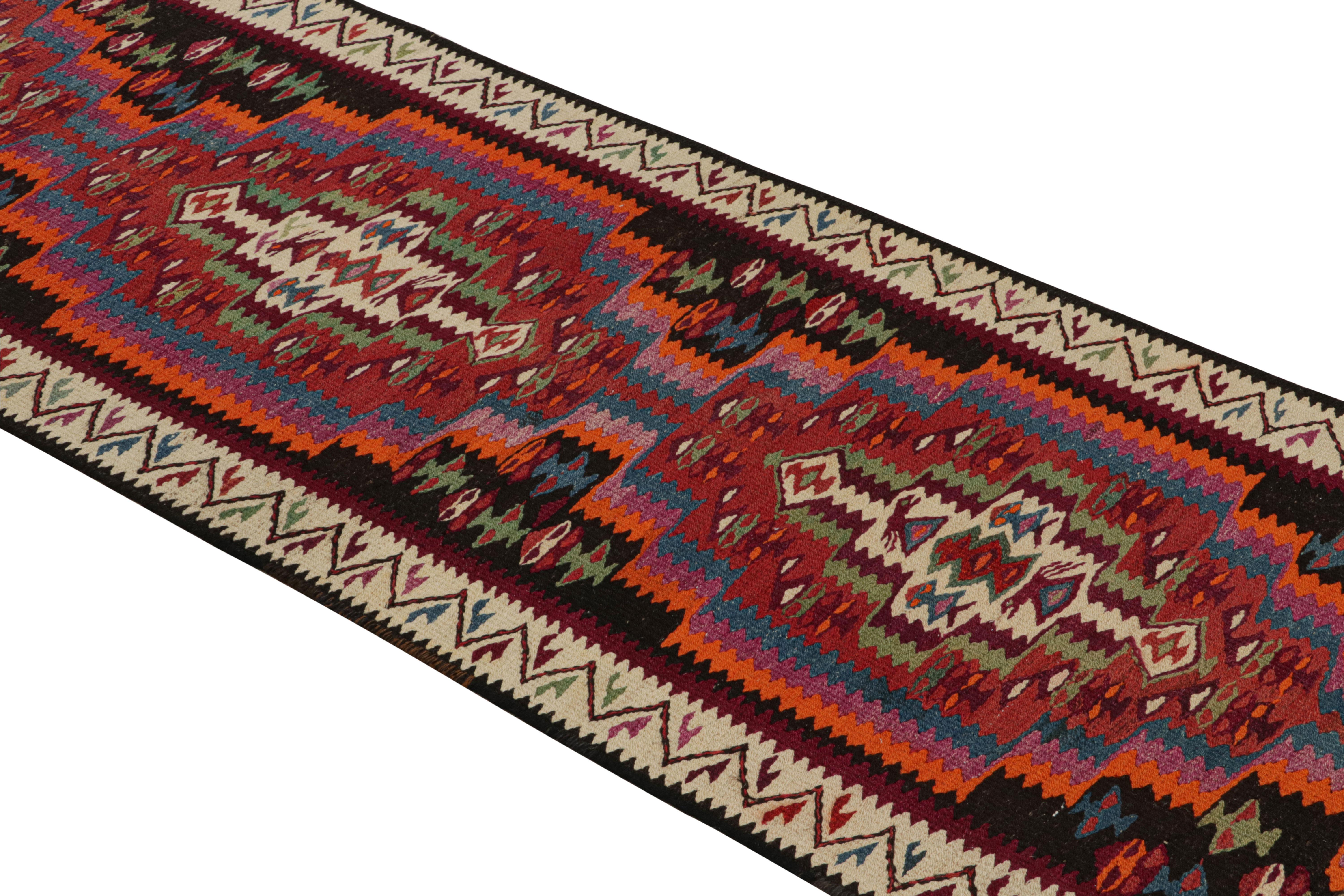 Handmade in a particularly full, durable flat-woven wool circa 1950-1960, this vintage Persian Kilim originates from the Harsin region of midcentury Kermanshah Kilim design, the period and locale remarking the superb quality and equally meticulous