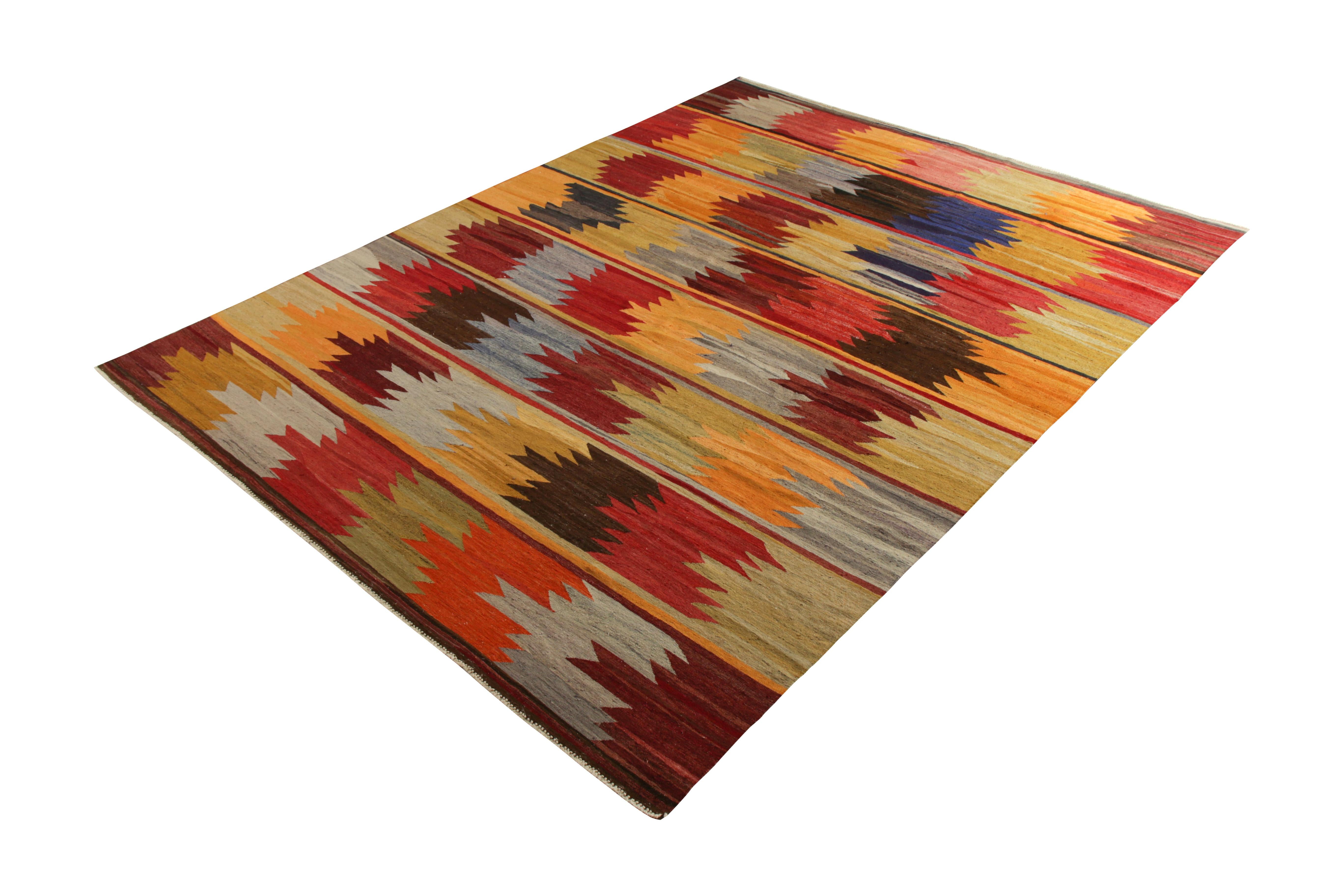 Handwoven in wool originating from Turkey circa 1950-1960, this item is a vintage Kilim rug connoting a midcentury Anatolian rug design emerging in this period, known for producing modern, almost maximalist rugs in the plays of color and pattern.