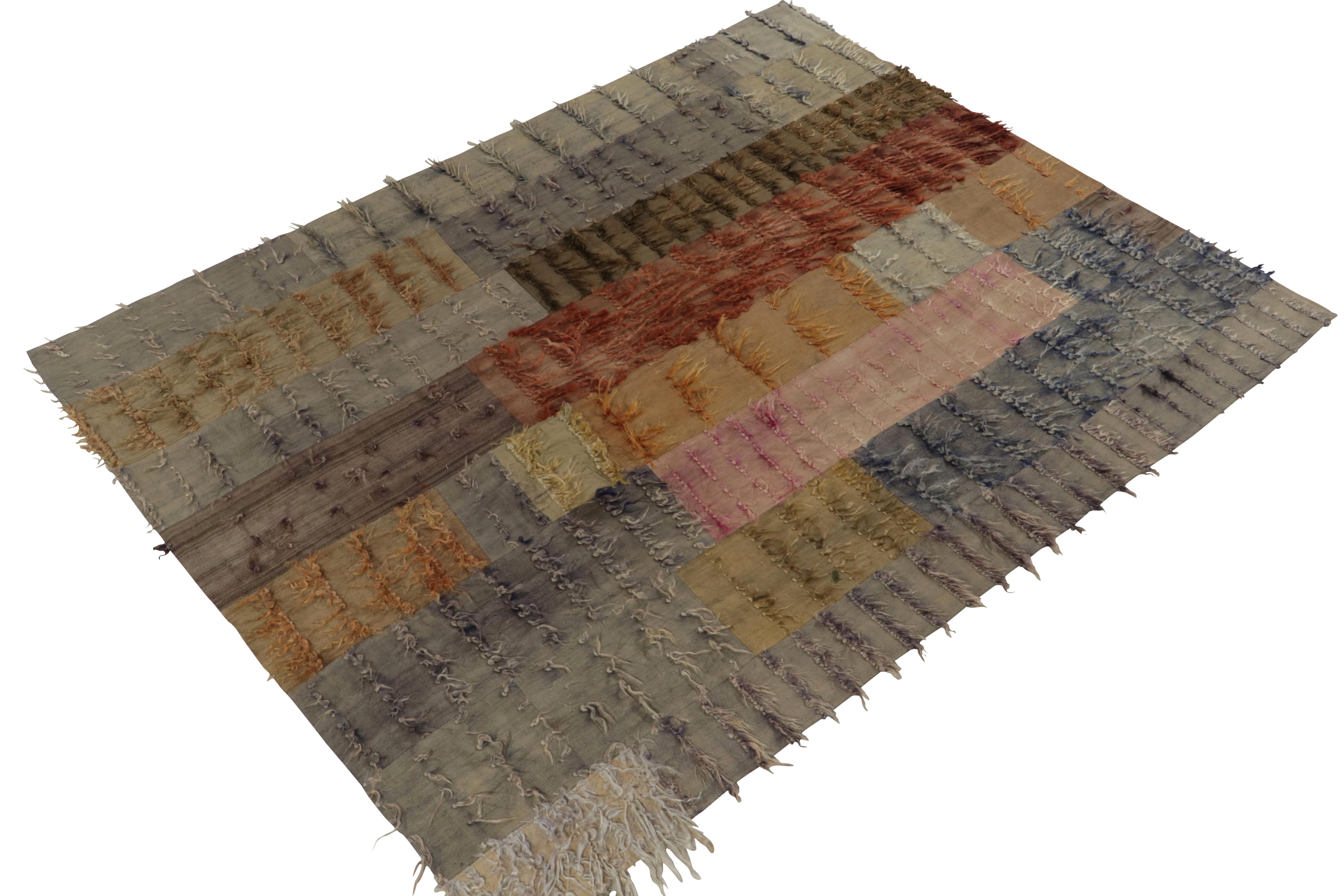 Hand knotted with wool n a rich and teeming angora yarn originating from Turkey between 1950-1960, this vintage midcentury Tulu rug enjoys a whimsical variety of textural high-low pile and smoothness in the play of the geometry and vibrant colorway.