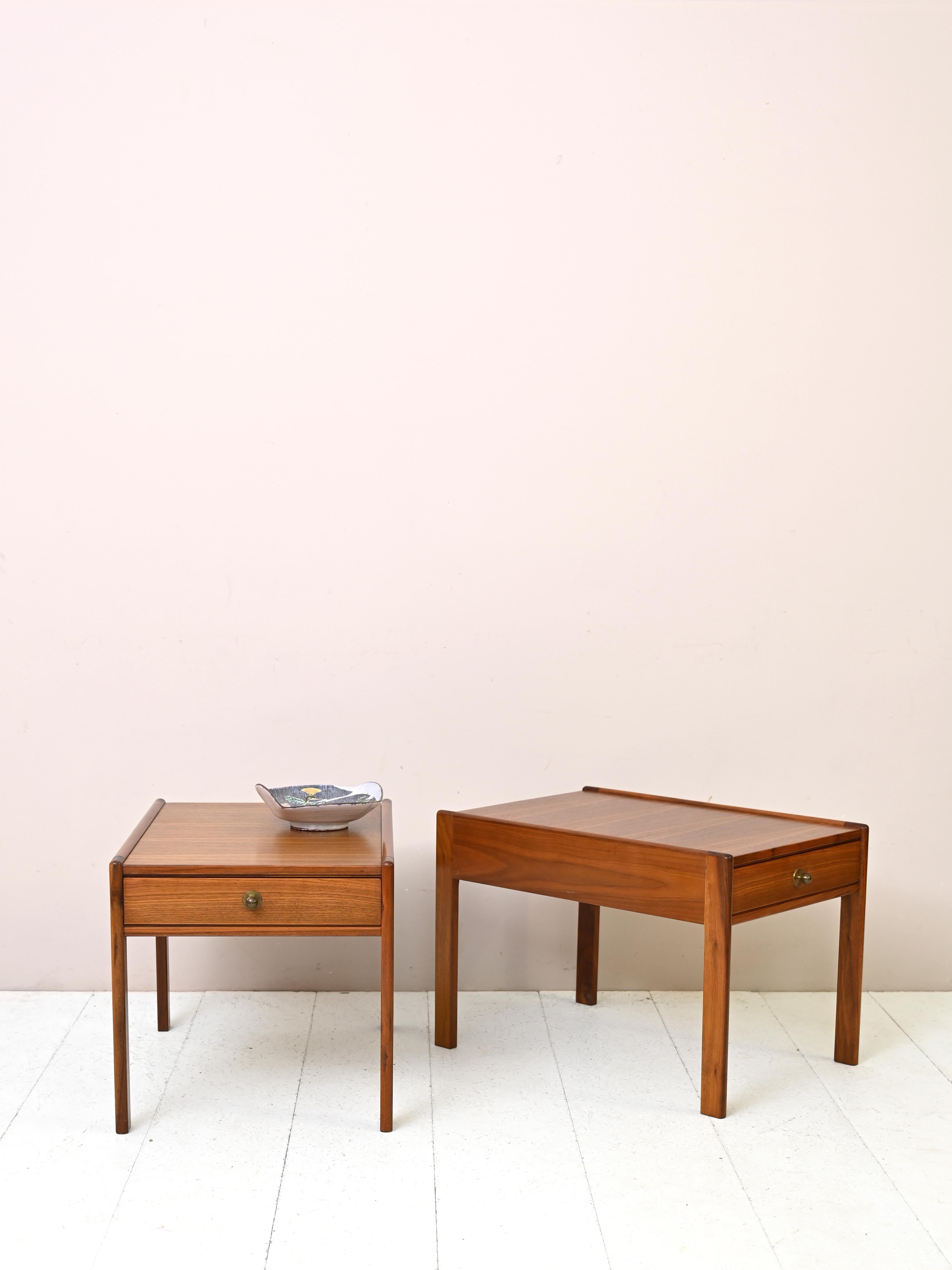 Vintage teak living room side tables.
An elegant set of two vintage teak side tables with classic and sophisticated lines. These side tables represent mastery in the art of Scandinavian design and are distinguished by their long, narrow shape,