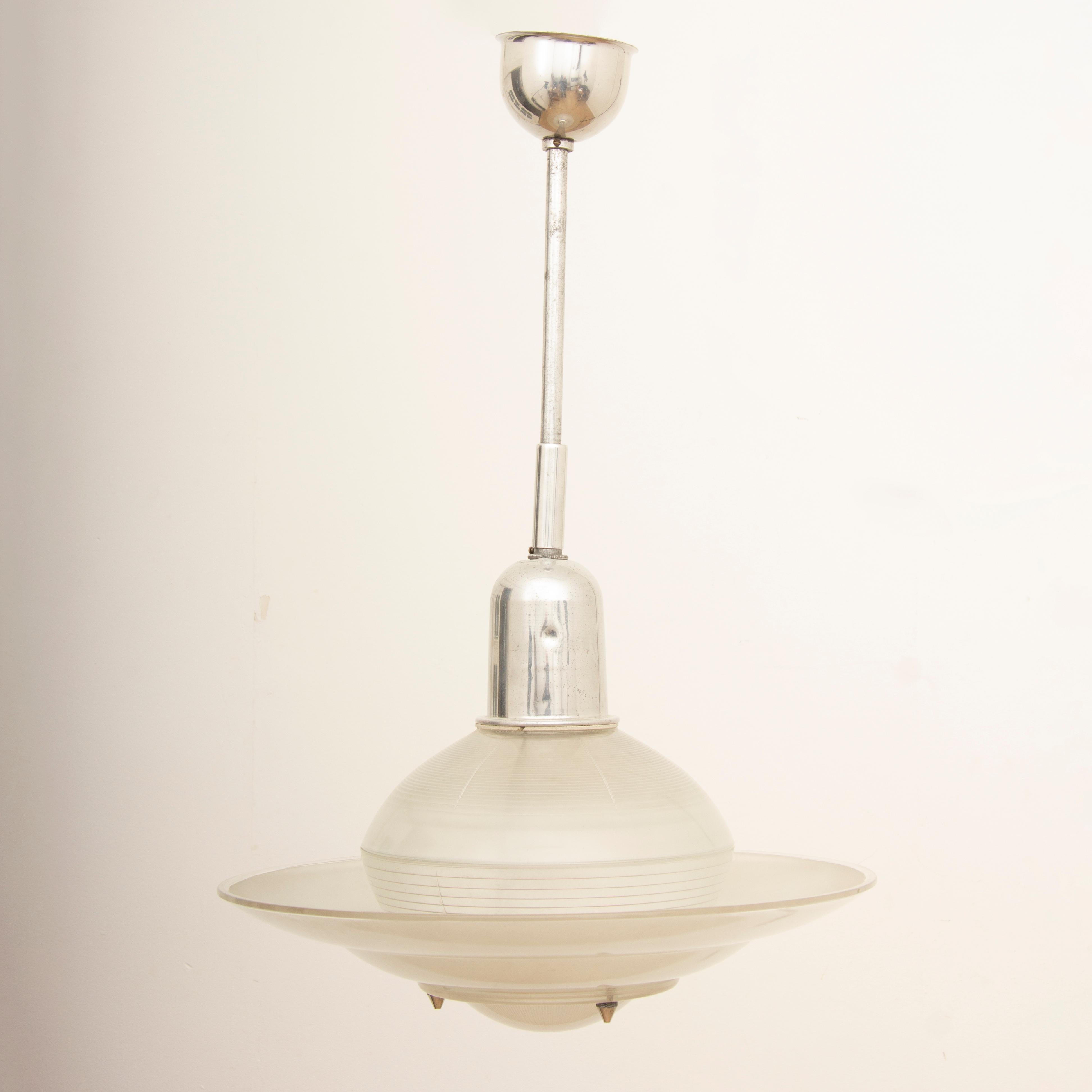 1950s Holophane hanging opaline and aluminium glass Space Age UFO light. The opaline glass shade is suspended from a matte aluminium fitting and rod with a matching cup at the top to hide the wires. The lower shade is fixed to the upper dome with