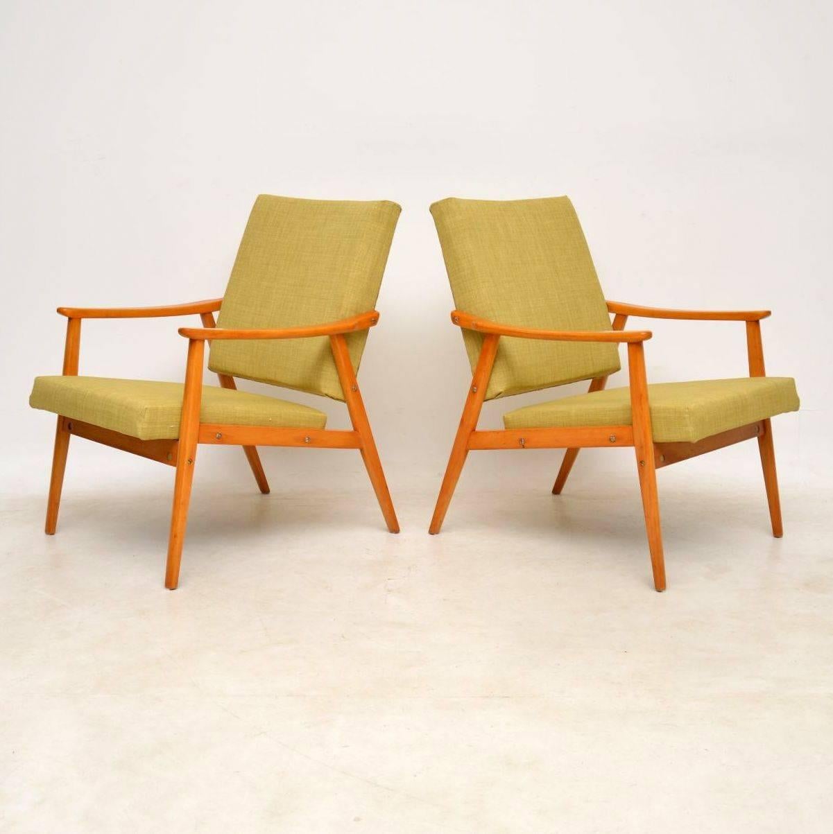 A stunning pair of vintage Danish armchairs, these date from around the 1950s-1960s. We have had the frames fully stripped and re-polished, the seats have also been fully re-upholstered in our light green fabric; the condition is excellent