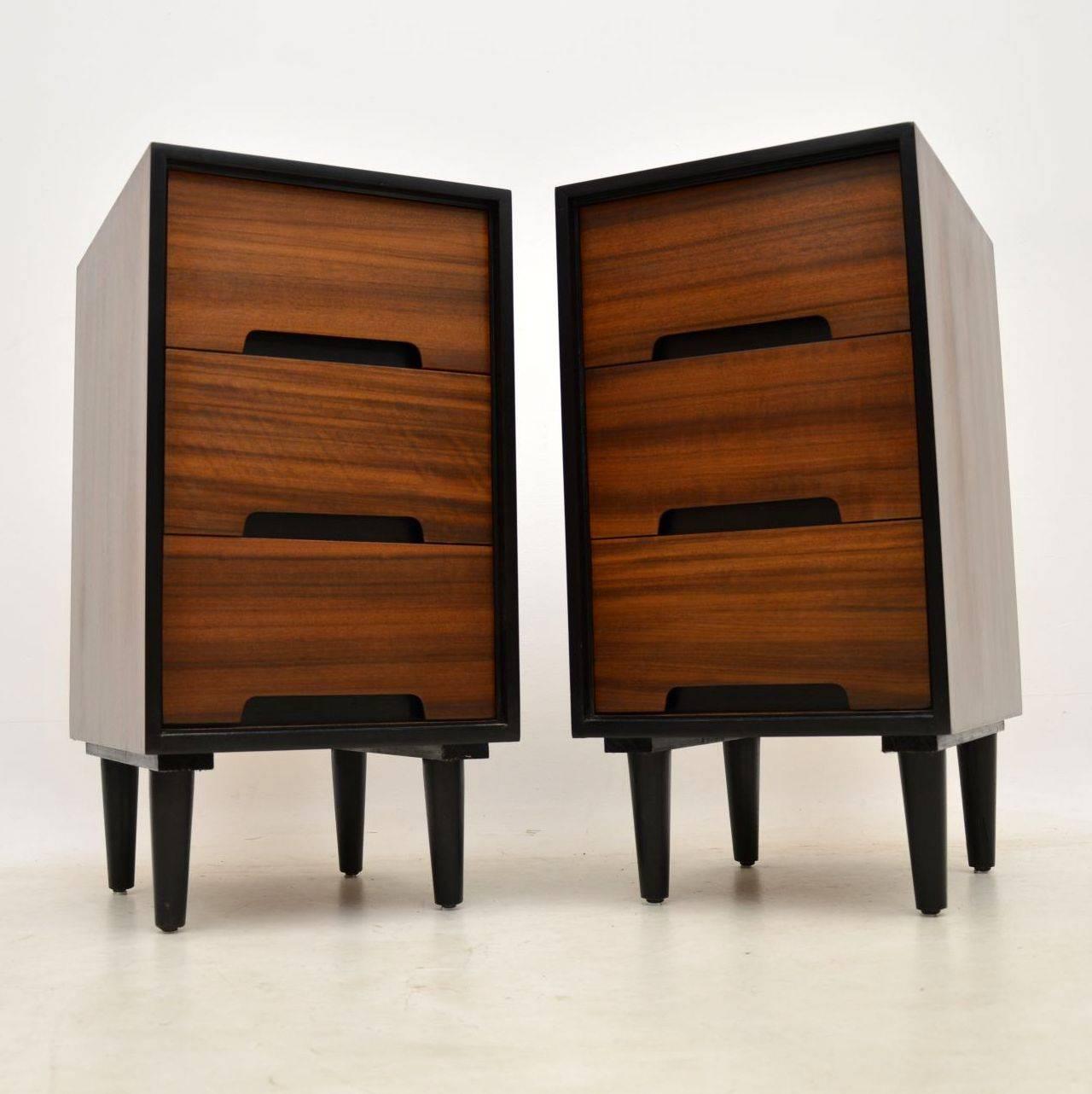 A stylish and practical pair of vintage bedside chests in walnut, these were designed by John & Sylvia Reid for Stag. They date from the 1950s, and they are in superb condition for their age, we have had them fully stripped and re-polished to a very