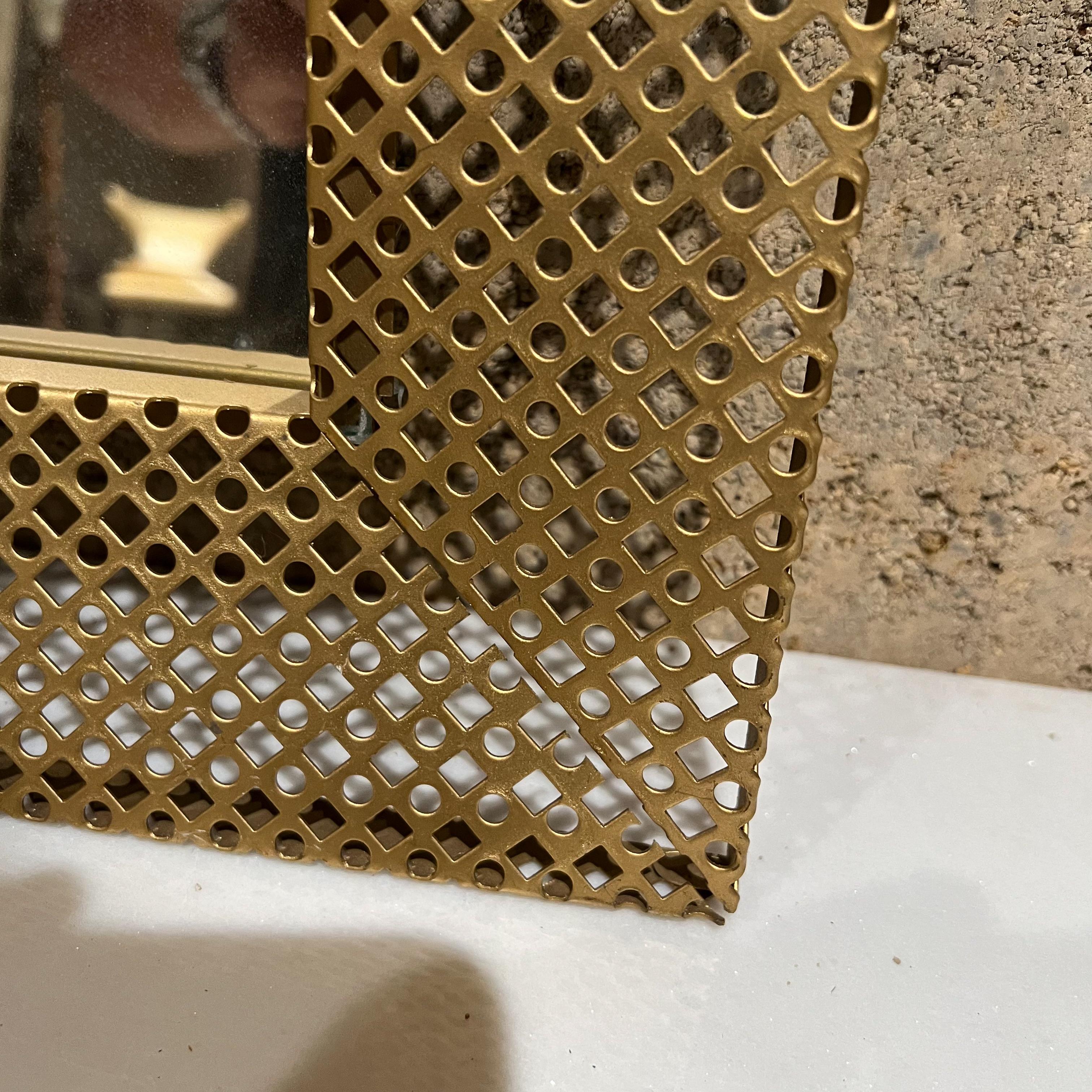 Italian vintage perforated gold metal mirror picture frame Italy 1950s 
In the style of Mathieu Mategot renowned French material artist
Measures: 14.63 x 12 W x 1.5 D
Original Preowned Vintage unrestored condition.
See images provided.


