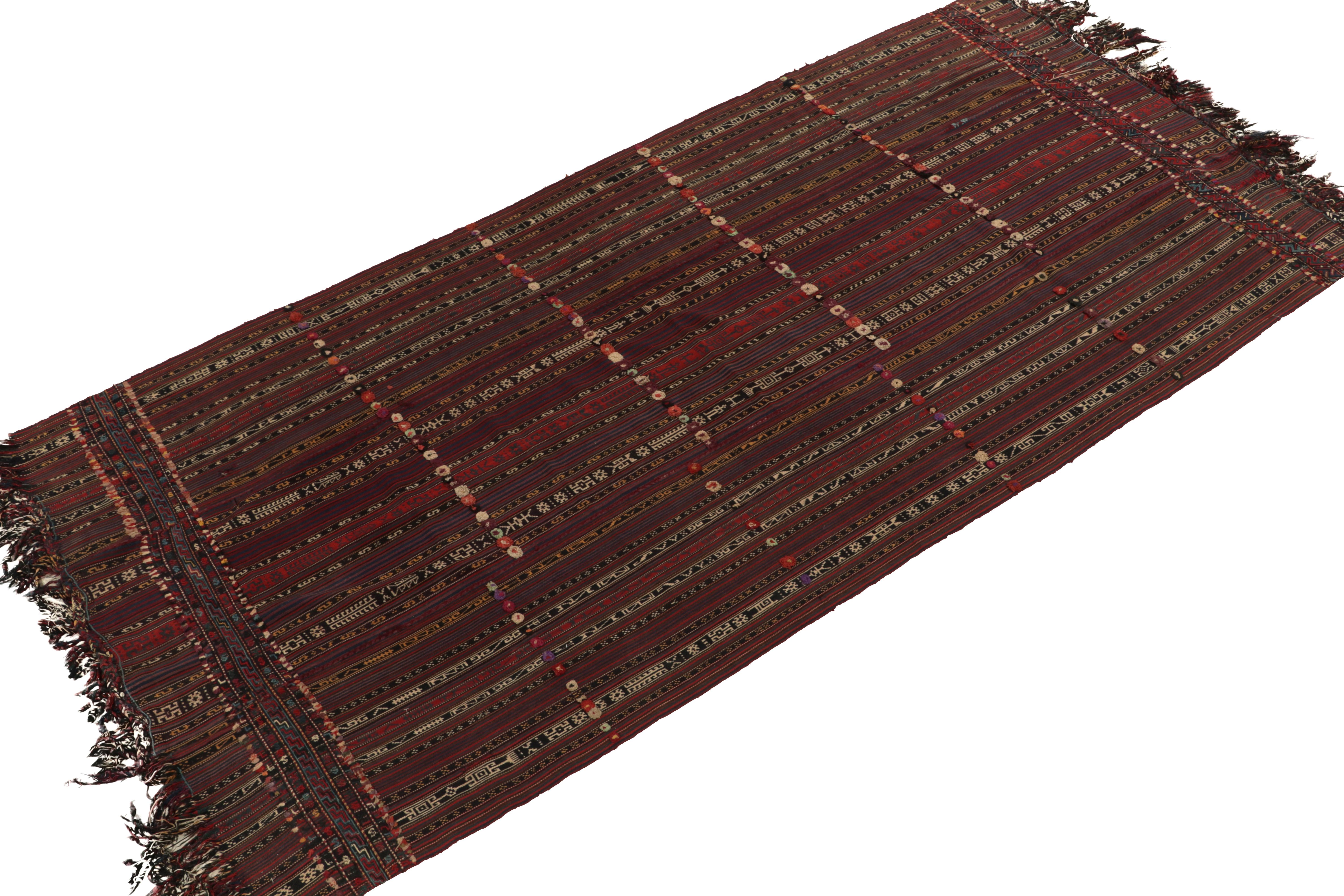 Handwoven in wool, a 5x10 Persian tribal Kilim originating circa 1950-1960. This particular rug style showcases a unique embroidery element in rich red & brown with colorful accents lending distinguished allure seldom seen in pieces from this era.