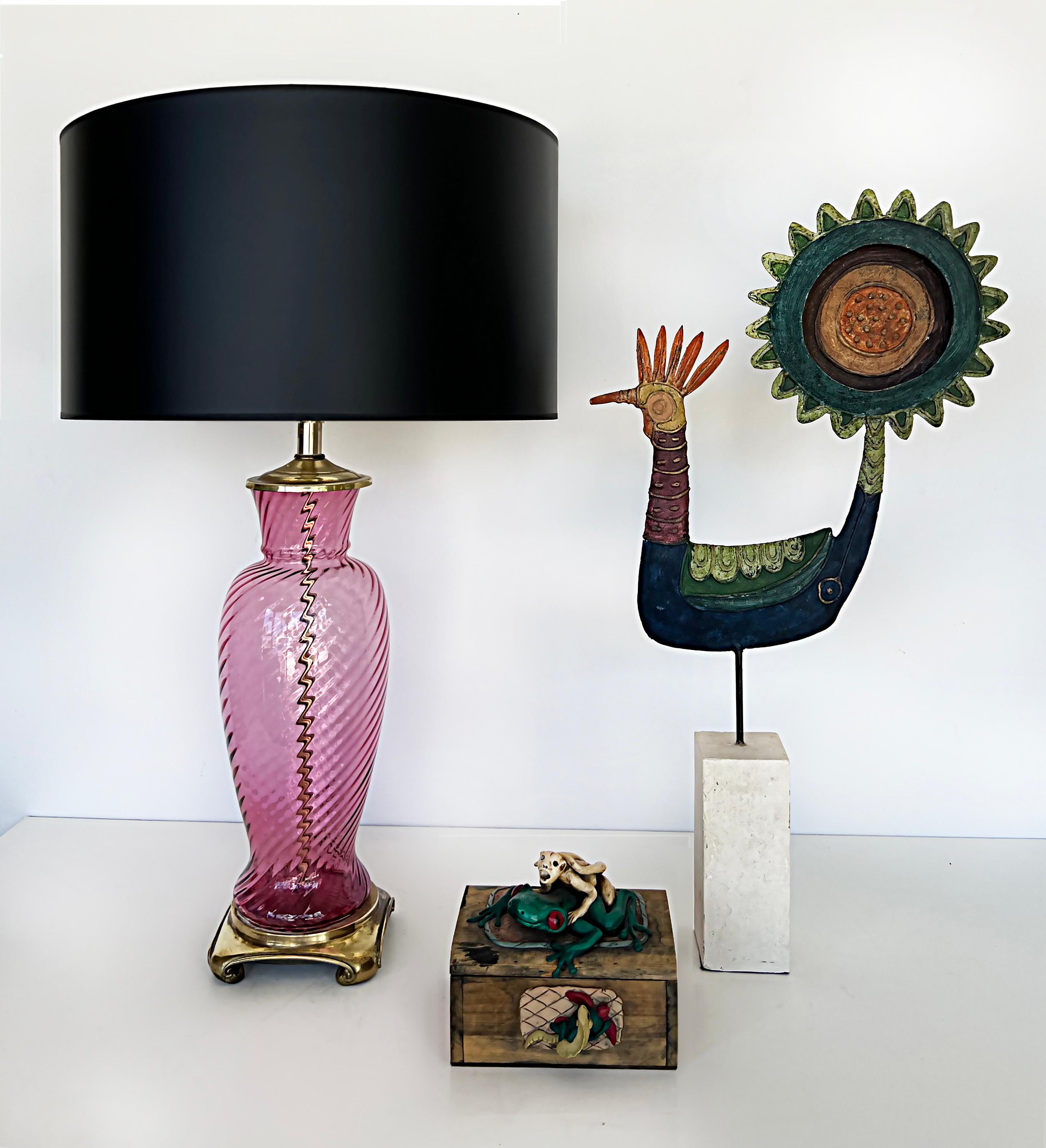 1950s Vintage pink murano glass table lamps, brass bases, pair.

Offered for sale is a pair of vintage pink swirl Murano glass lamps with a ridged texture. These circa 1950s lamps are presented upon solid brass bases and have brass fittings. The