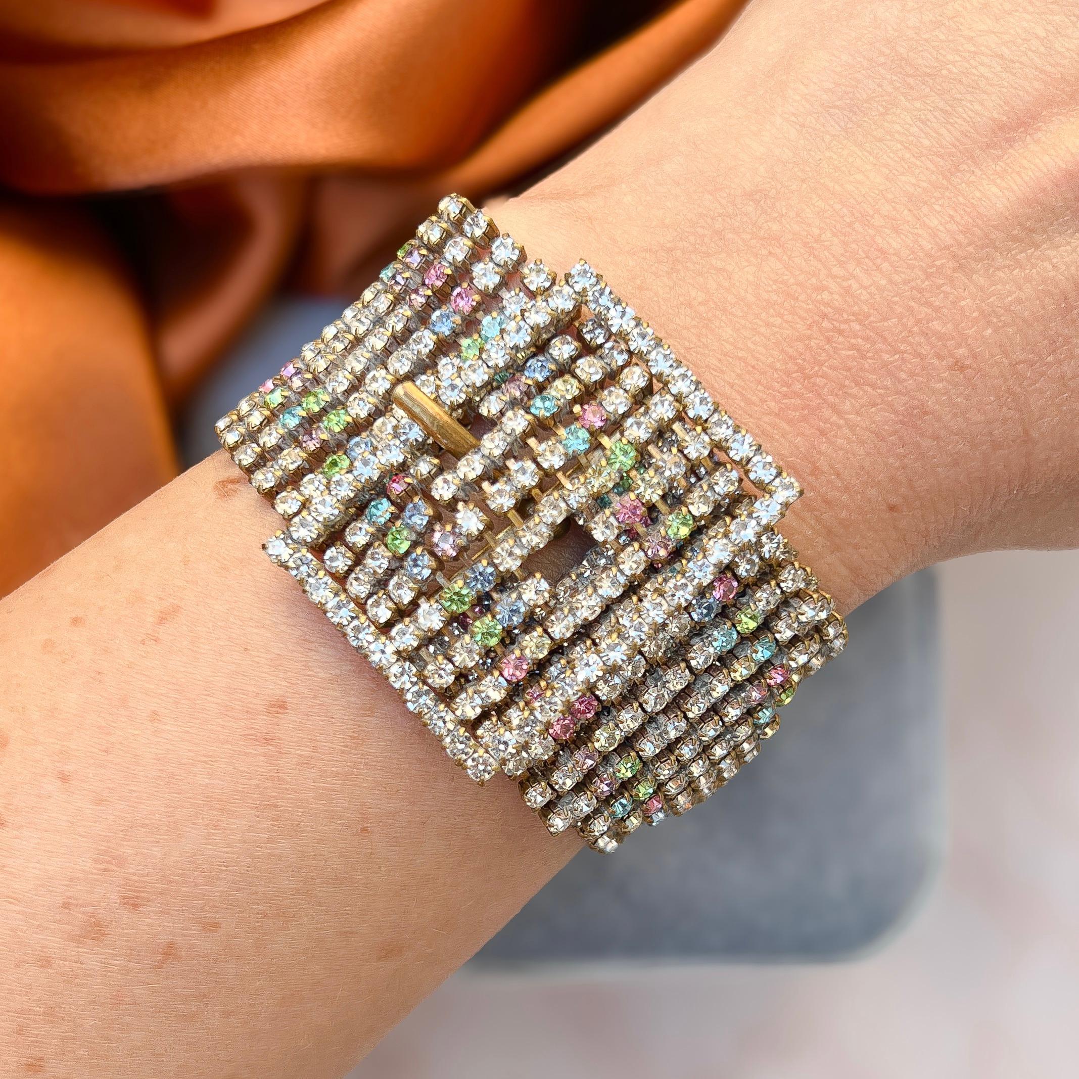 This unusual and striking bracelet dates from the 1950s. 

Condition Report:
Excellent

The Details...
This bracelet is constructed from gilded metal. It features a belt and buckle design and fastens around the wrist as a belt would - with the tail