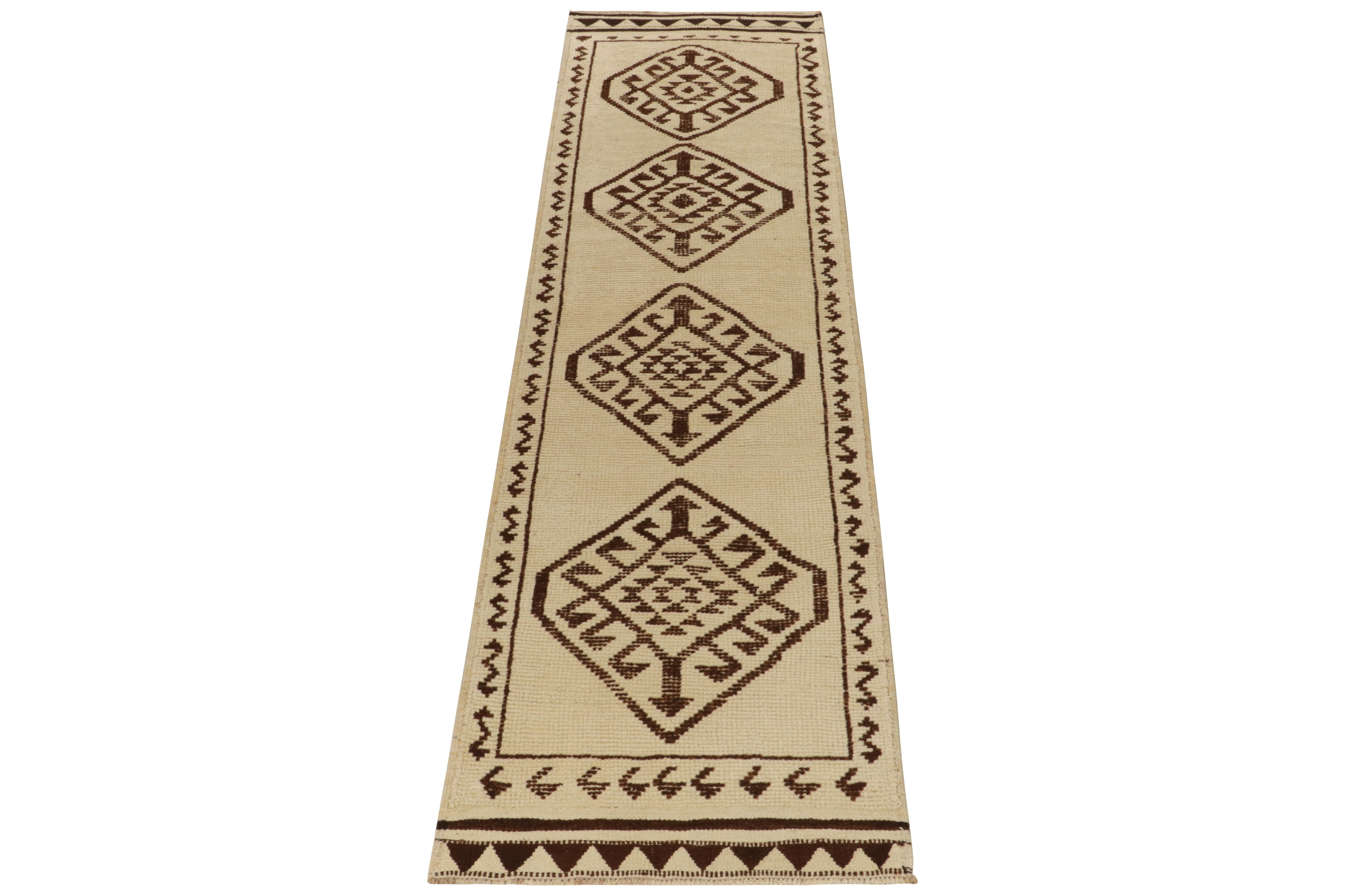 From our vintage selections, a 3x12 hand-knotted runner bearing clean nomadic aesthetics. 

This particular 1950s tribal piece showcases traditional motifs neatly decorating the field in comfortable beige browns, further attributing to the