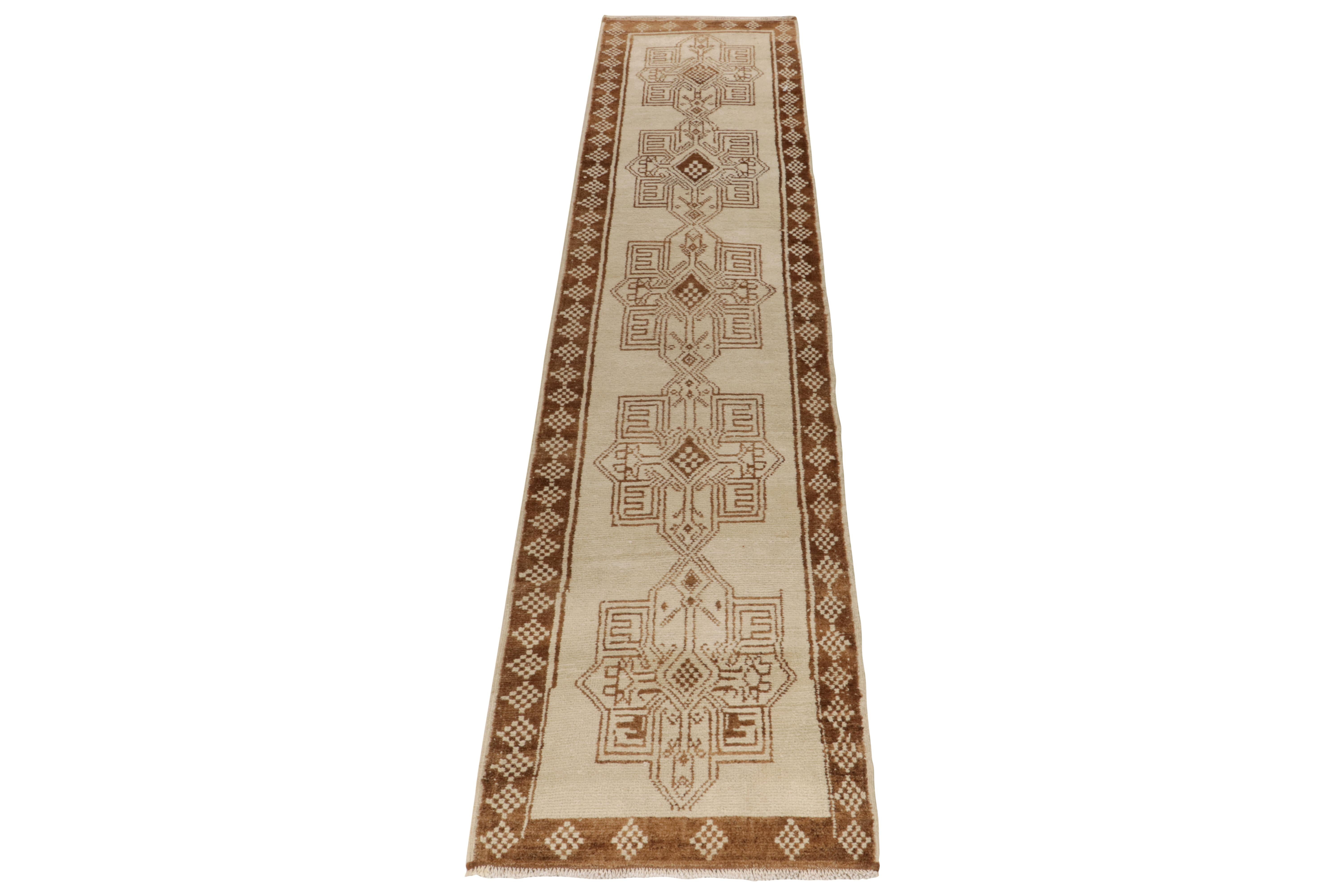 From Rug & Kilim’s vintage selections, a 3 x 15 hand-knotted runner bearing strong nomadic influence. The 1950s tribal piece showcases traditional motifs sitting peacefully like medallions on the field in crisp white & variegated brown tones further