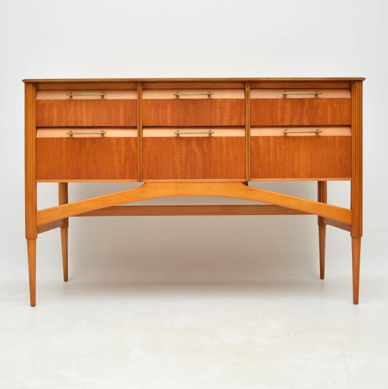A beautiful and very well made vintage sideboard in satinwood, with brass handles. This dates from the 1950-1960s, we have had it stripped and re-polished to a very high standard, the condition is superb throughout. Its a useful size, elegant and