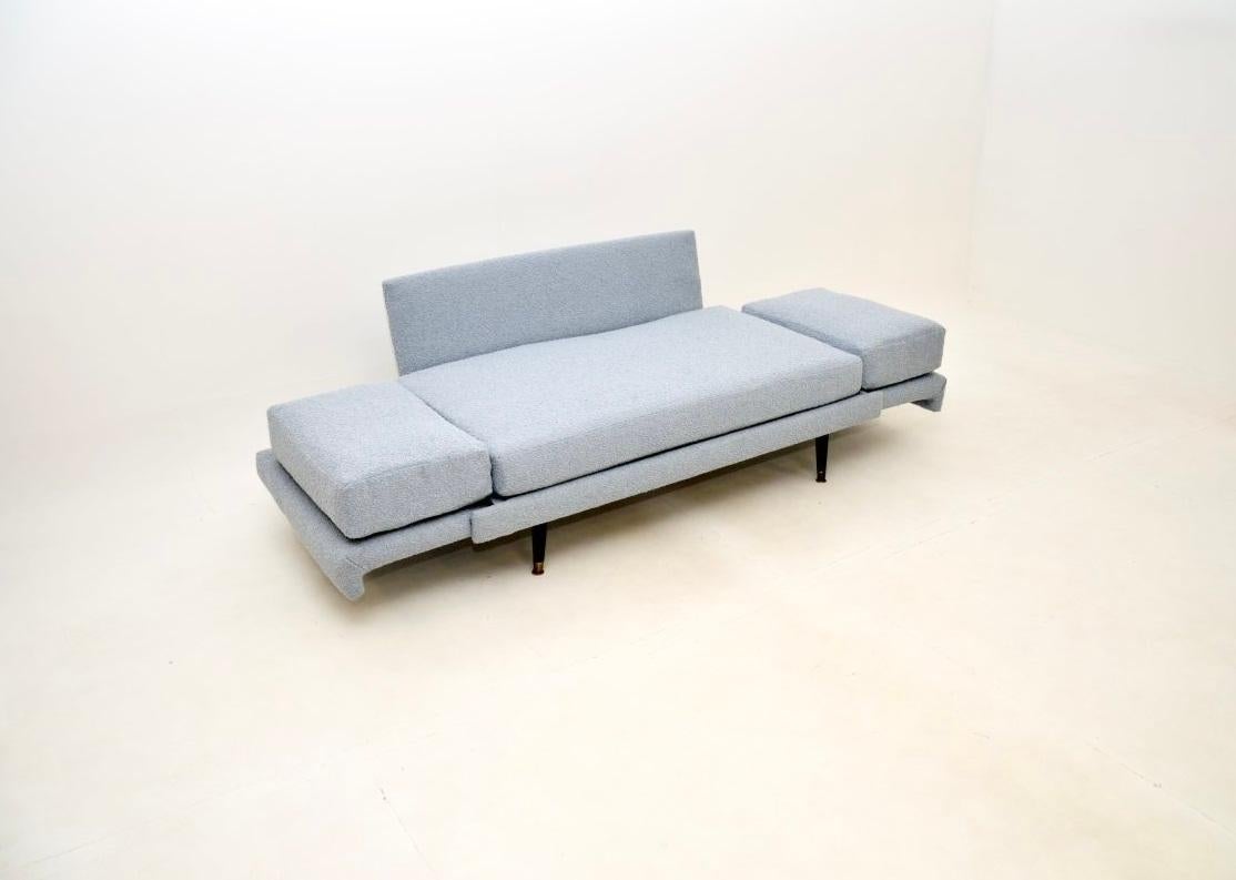 A stylish and extremely comfortable 1950’s vintage sofa bed, made in England.

It has a lovely design and is of great quality. The arm rests lift up and drop down to support the back cushions and turn this into a decent sized guest bed. The cushions