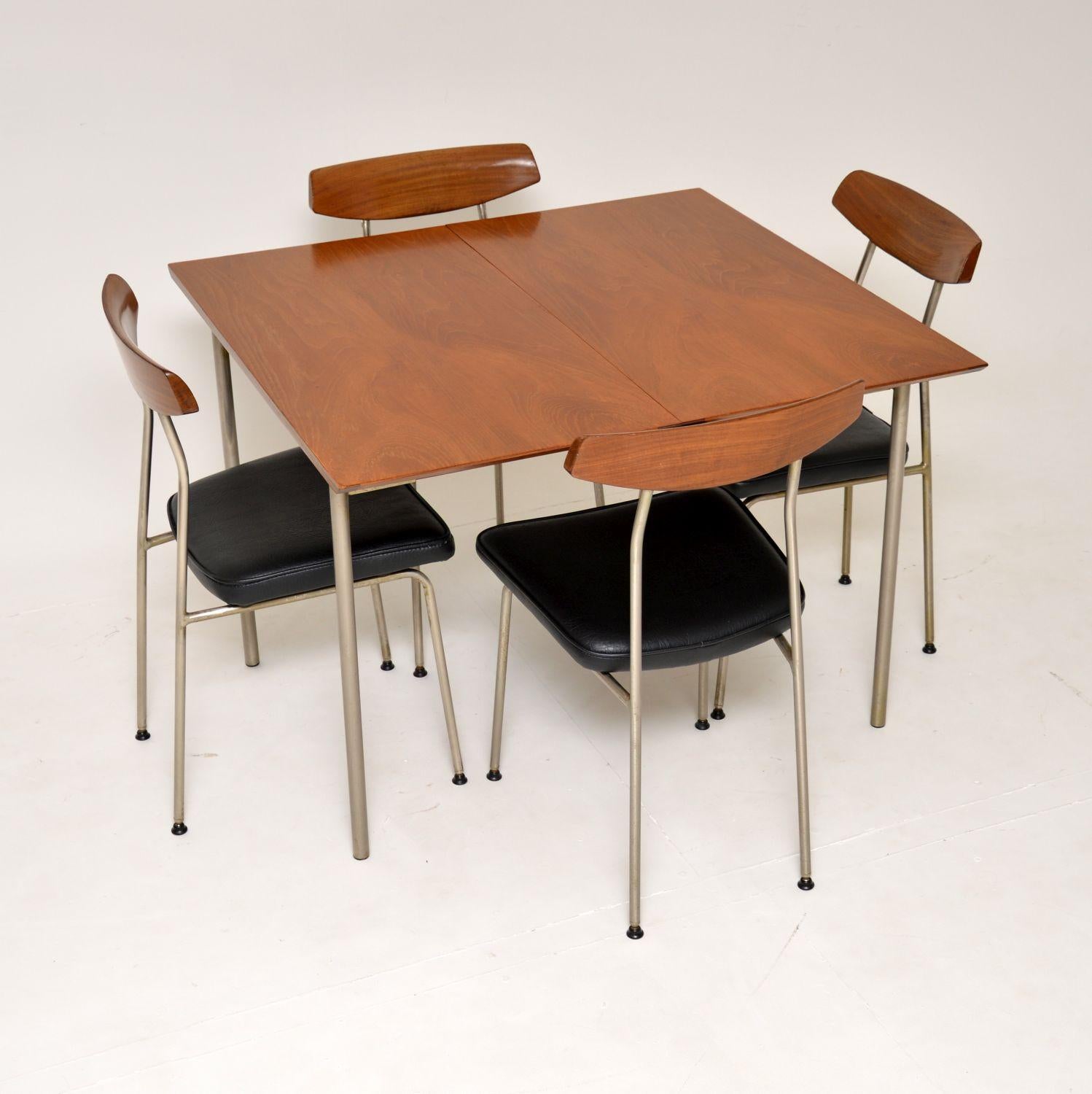 An extremely stylish and iconic design, this dining table and chairs were made in England by Stag in the 1950’s. They are part of the award winning S Range design by husband and wife team John and Sylvia Reid.

The table top is teak and back rests