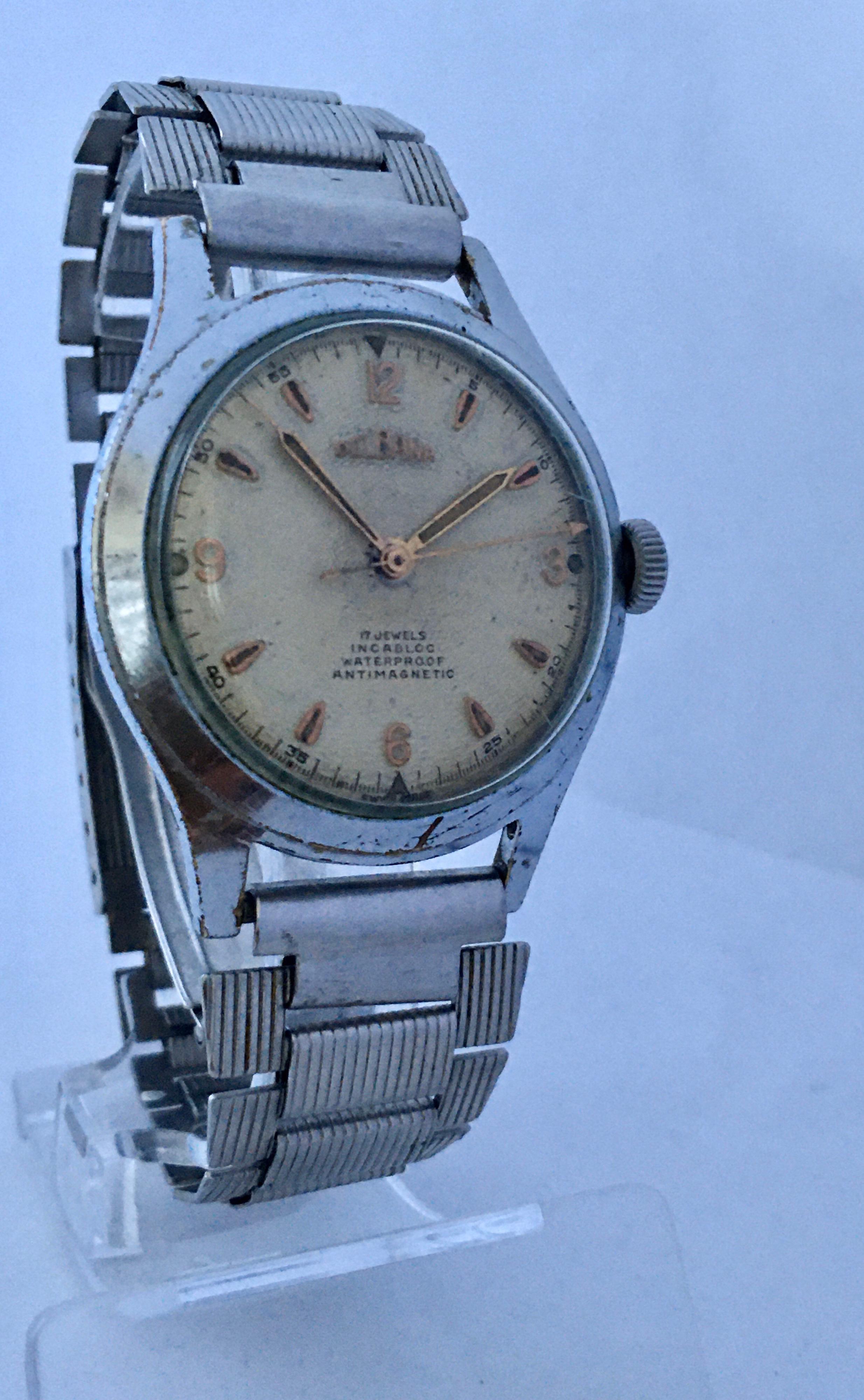 This beautiful pre-owned vintage manual winding watch is working and it is ticking and runs well. Visible signs of ageing and wear with some scratches on the watch case, glass  and on the strap. There are some worn and slight tarnish on watch case