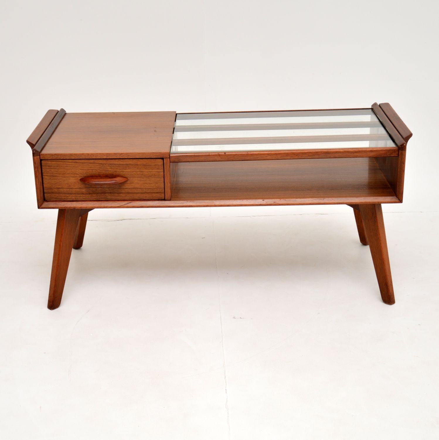 A beautifully styled vintage coffee table by G- Plan, this dates from circa 1950s-1960s. It’s of great quality, made from tola wood, with an inset glass top.

This is in nice vintage condition, with some minor surface wear here and there. This in