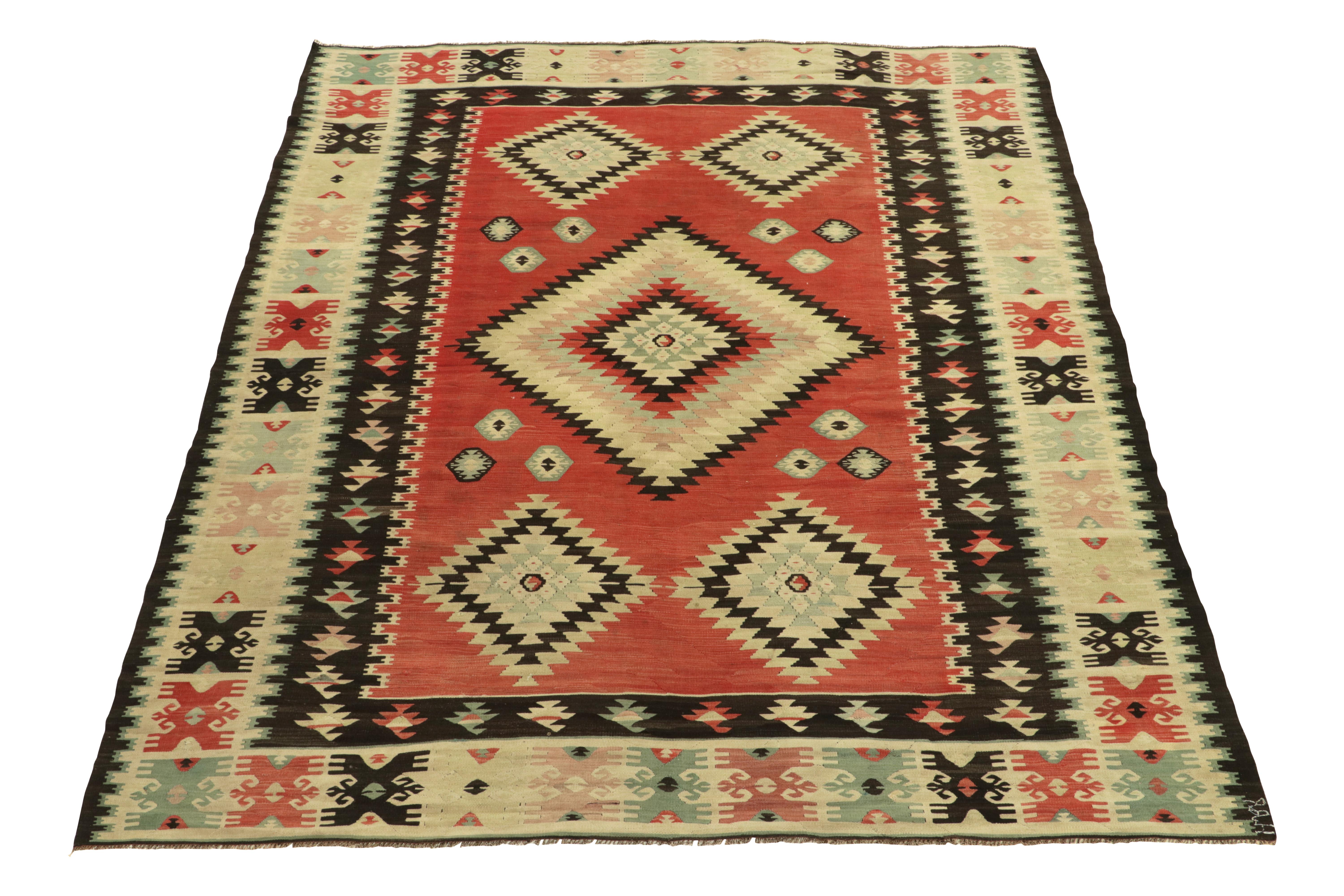 Handwoven in wool, this 8x9 vintage tribal kilim rug remarks a prestigious addition in our flatweave collection. This rare mid-century flatweave from Turkey features a tribal pattern & abrashed striations of black beneath the prevalent pink, blue