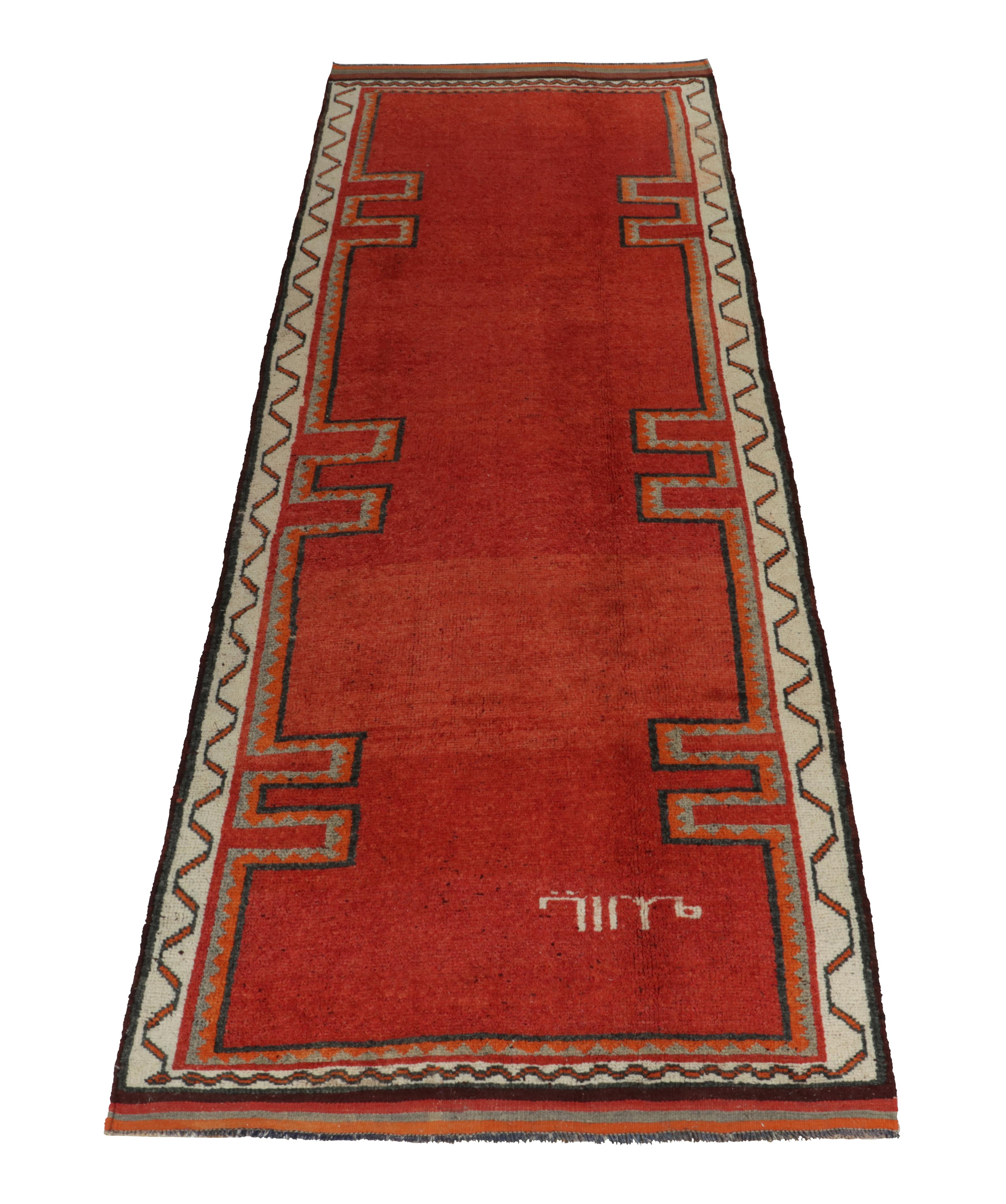 Hand-knotted in wool, a 4x12 rug from Rug & Kilim’s latest prominent curation of rare tribal pieces. 

Originating from Turkey circa 1950-1960, the piece enjoys a seldom-seen open field in this design with rich tones of red, complemented