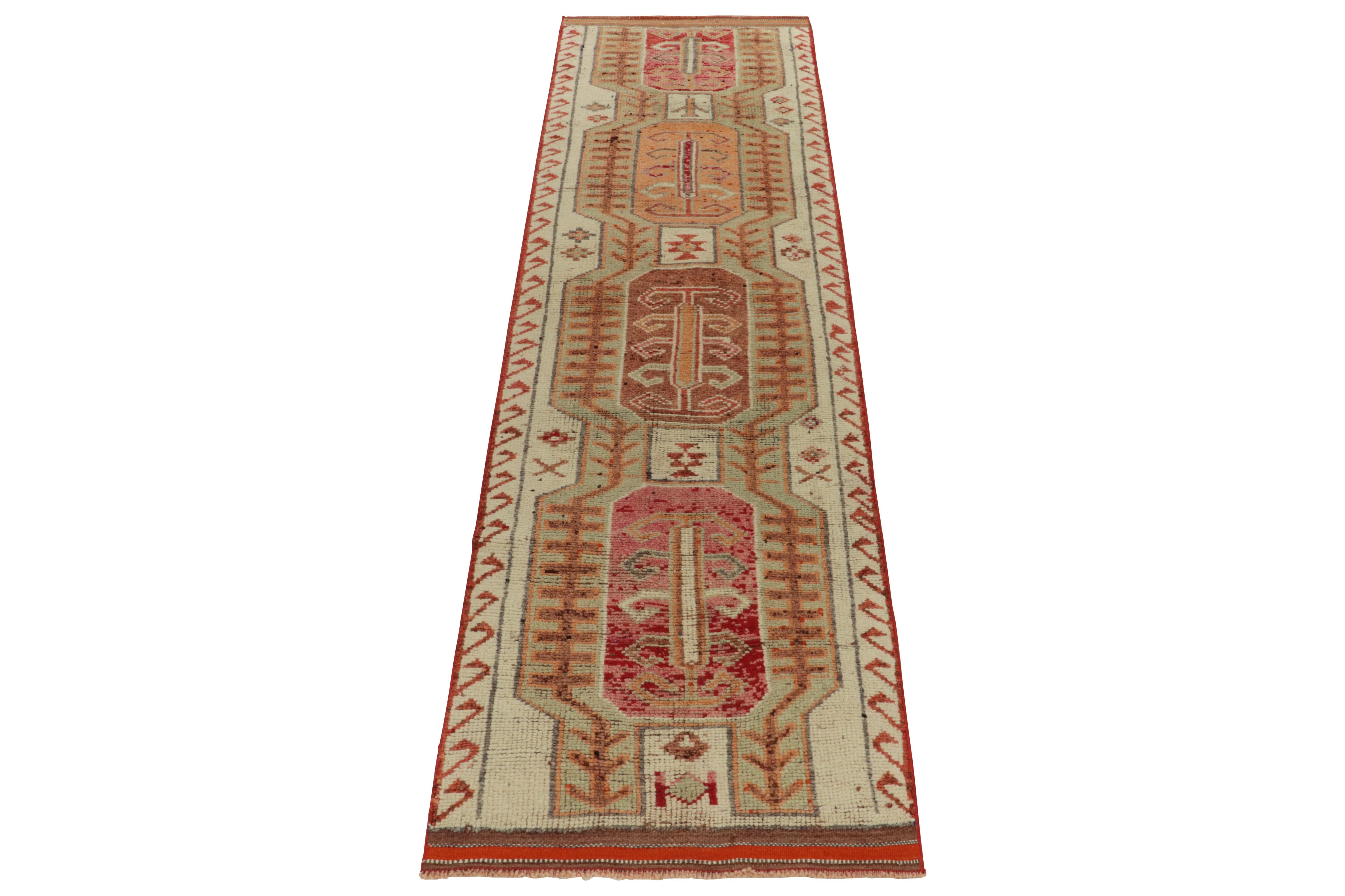 From Rug & Kilim’s vintage selections, a 3x12 hand-knotted runner bearing strong nomadic influence. The 1950s tribal piece showcases traditional motifs sitting peacefully like medallions on the field in off white & variegated brown, tomato red,
