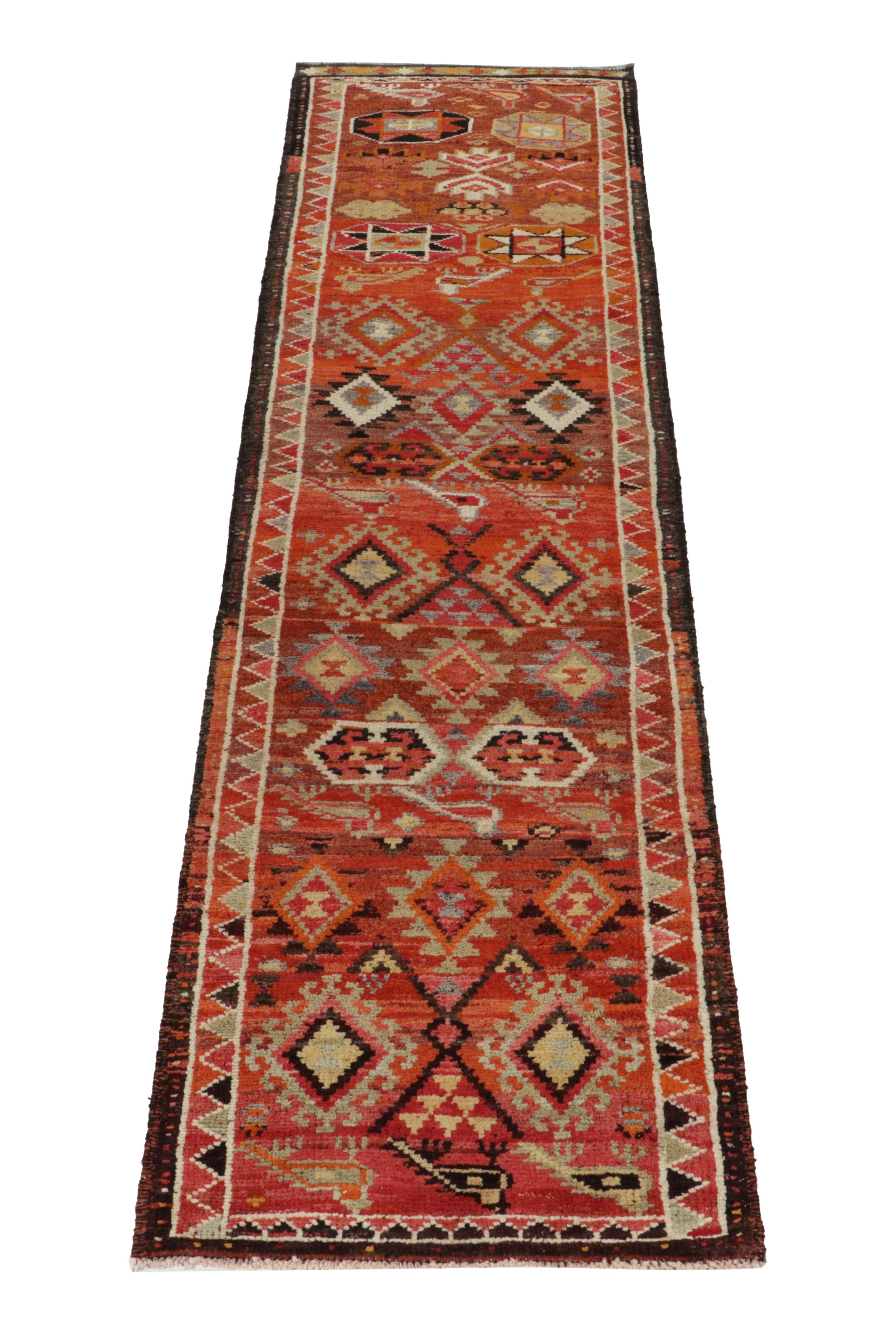 Hand-knotted in wool, a 3x11 runner from Rug & Kilim’s newly unvailed curation of rare tribal pieces. 

Originating from Turkey circa 1950-1960, the rug enjoys hexagons & traditional motifs on the field in warm tones of orange, red, pink, brown,