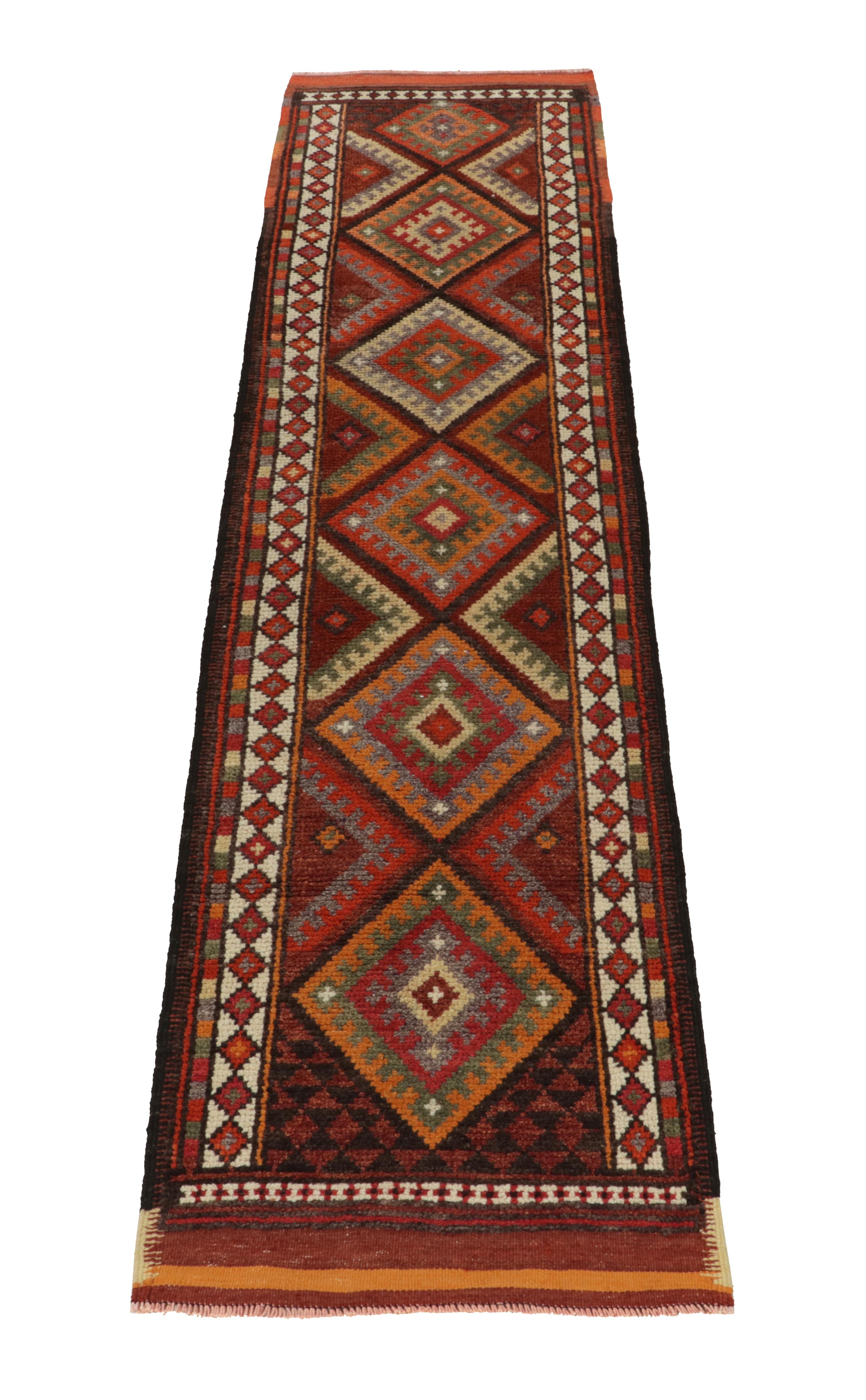 Hand-knotted in wool, a 3x12 runner from Rug & Kilim’s latest curation of rare, vibrant tribal rugs. 

Originating from Turkey circa 1950-1960, the design relishes a symmetric diamond pattern in rich orange, red, blue, green & black of