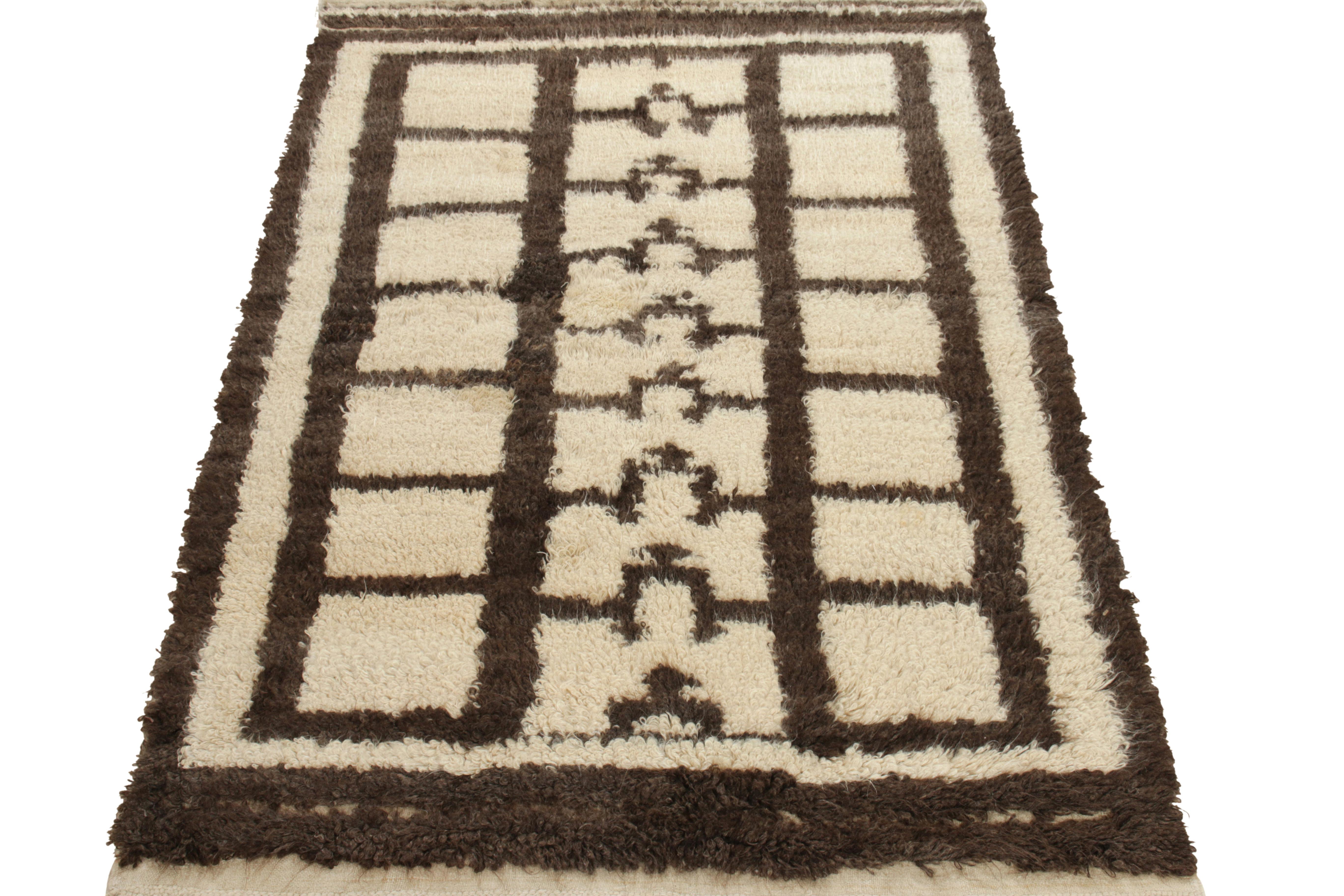 A 4X6 Tulu rug from Turkey entering rug & Kilim’s Antique & Vintage collection. The piece is hand-knotted in a fine wool shag pile with high low texturability on the border for enhancing the appeal of the tribal geometric pattern of the 1950s.