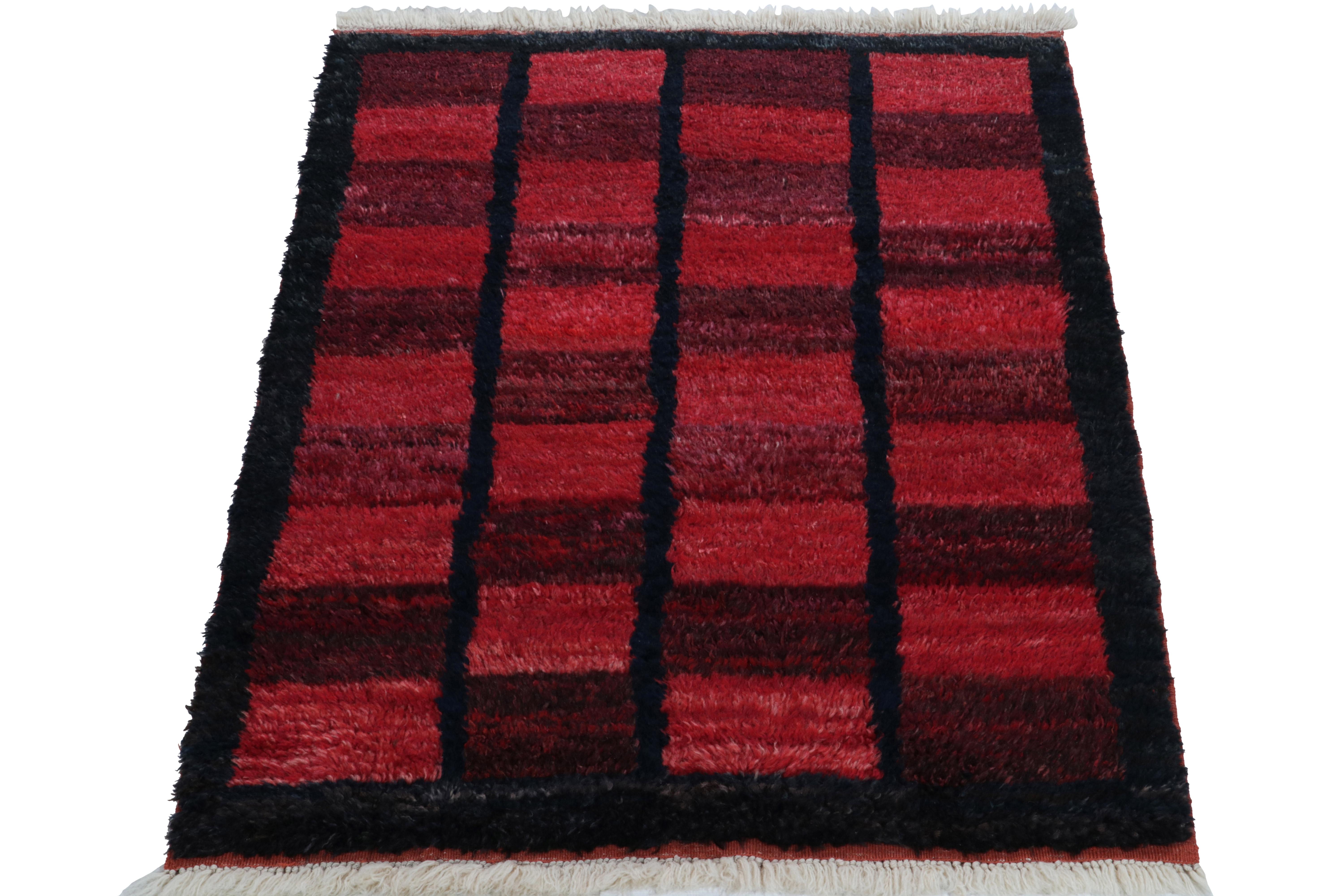Hand-knotted in wool, a 3x5 vintage Tulu rug originating from Turkey circa 1950-1960, now joining Rug & Kilim’s Antique & Vintage collection. The rug enjoys mid century aesthetics with a well defined geometric pattern in deep blue, carrot red &
