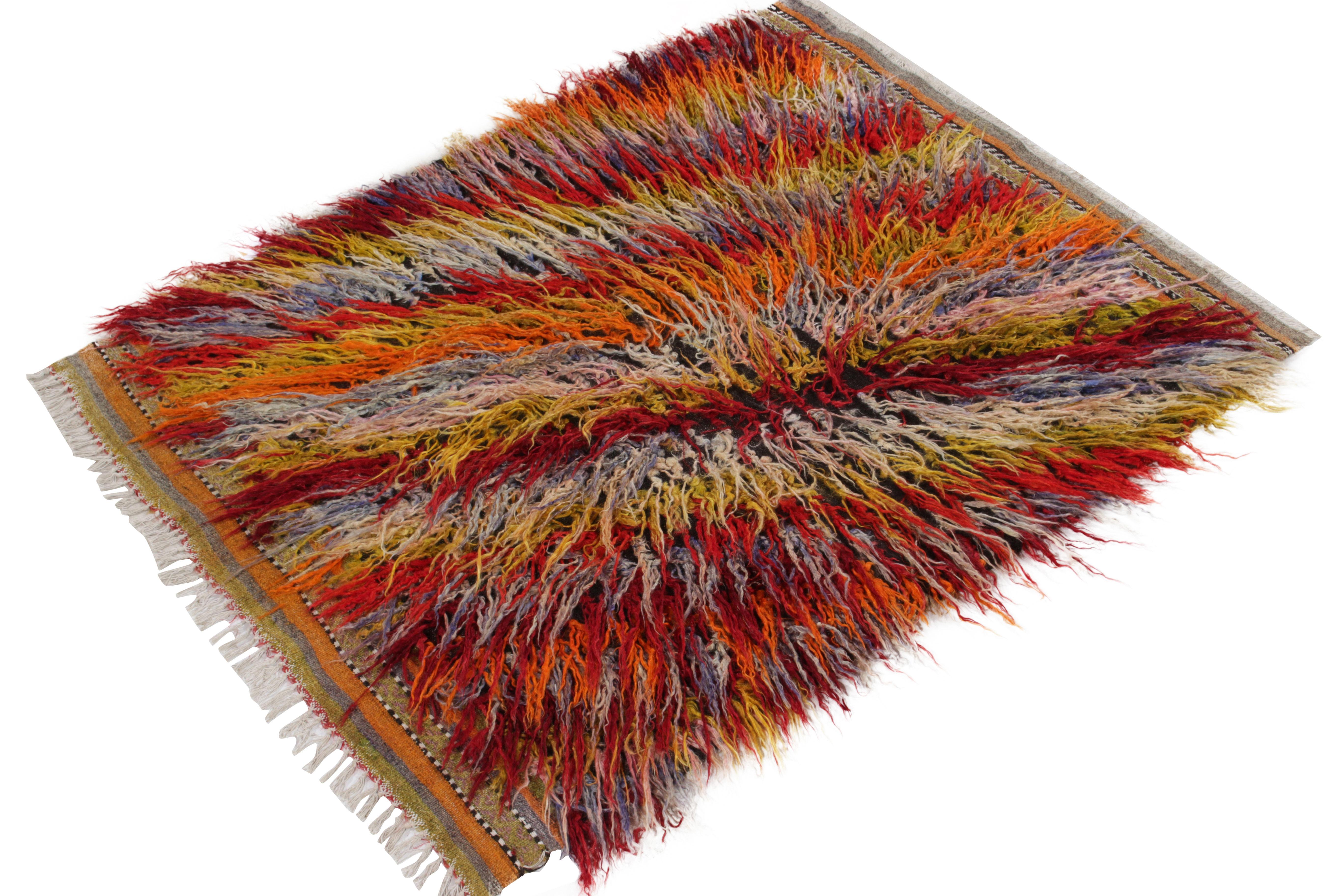 A 4x5 vintage Tulu rug from Turkey emanating exceptional mid-century aesthetics with high low texturability in a multicolor shag pile. Hand-knotted in fine wool, this rug further brings liveliness with a tribal design inspiration in red, yellow,