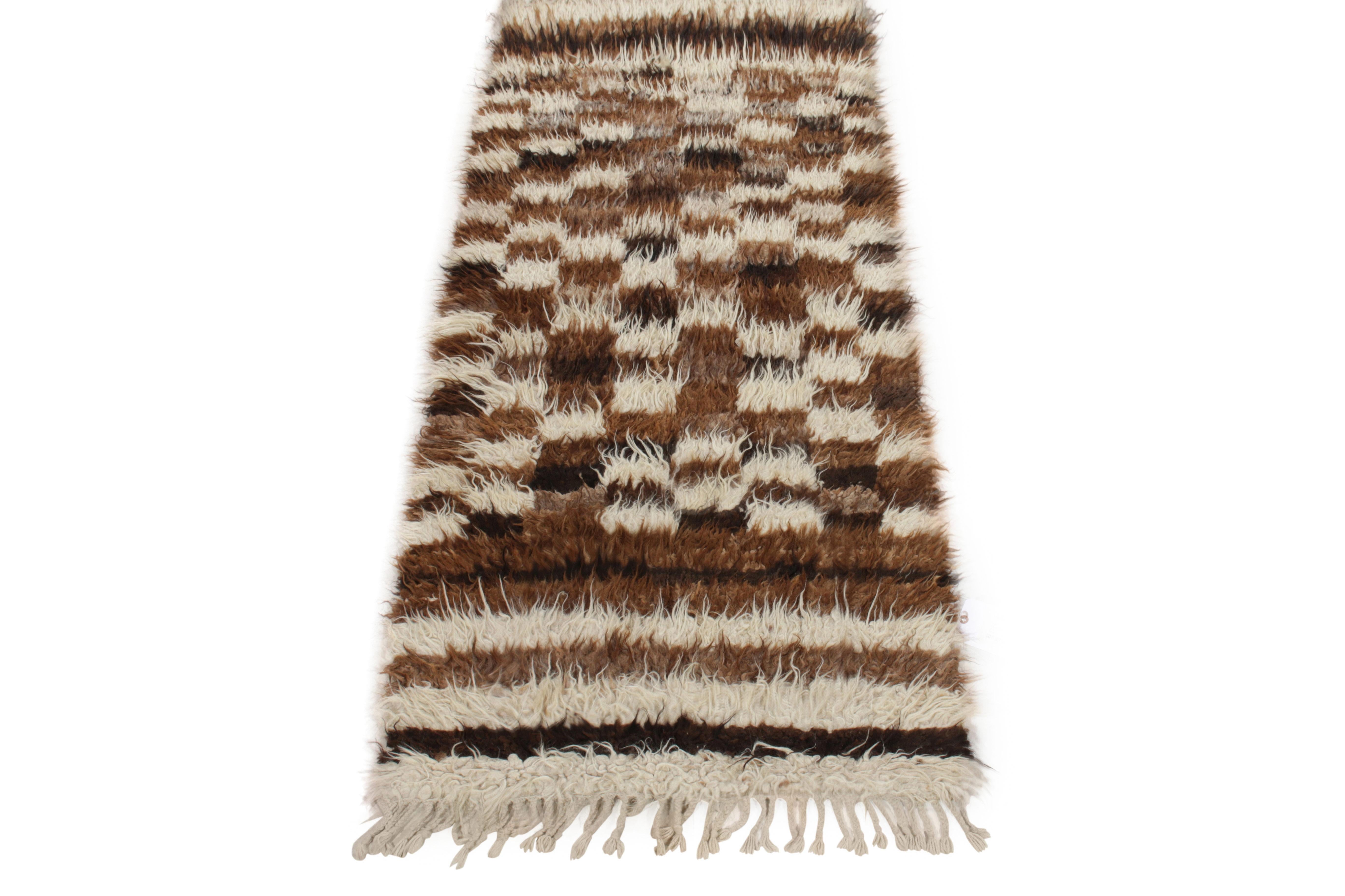 Dieser handgeknüpfte Tulu-Läufer mit einer Größe von 3x7 stammt aus der Türkei (ca. 1950-1960) und gehört jetzt zur Antik- und Vintage-Kollektion von Rug & Kilim. Der Zottelflor begleitet das gut definierte Karomuster und die Streifen, die bequem in