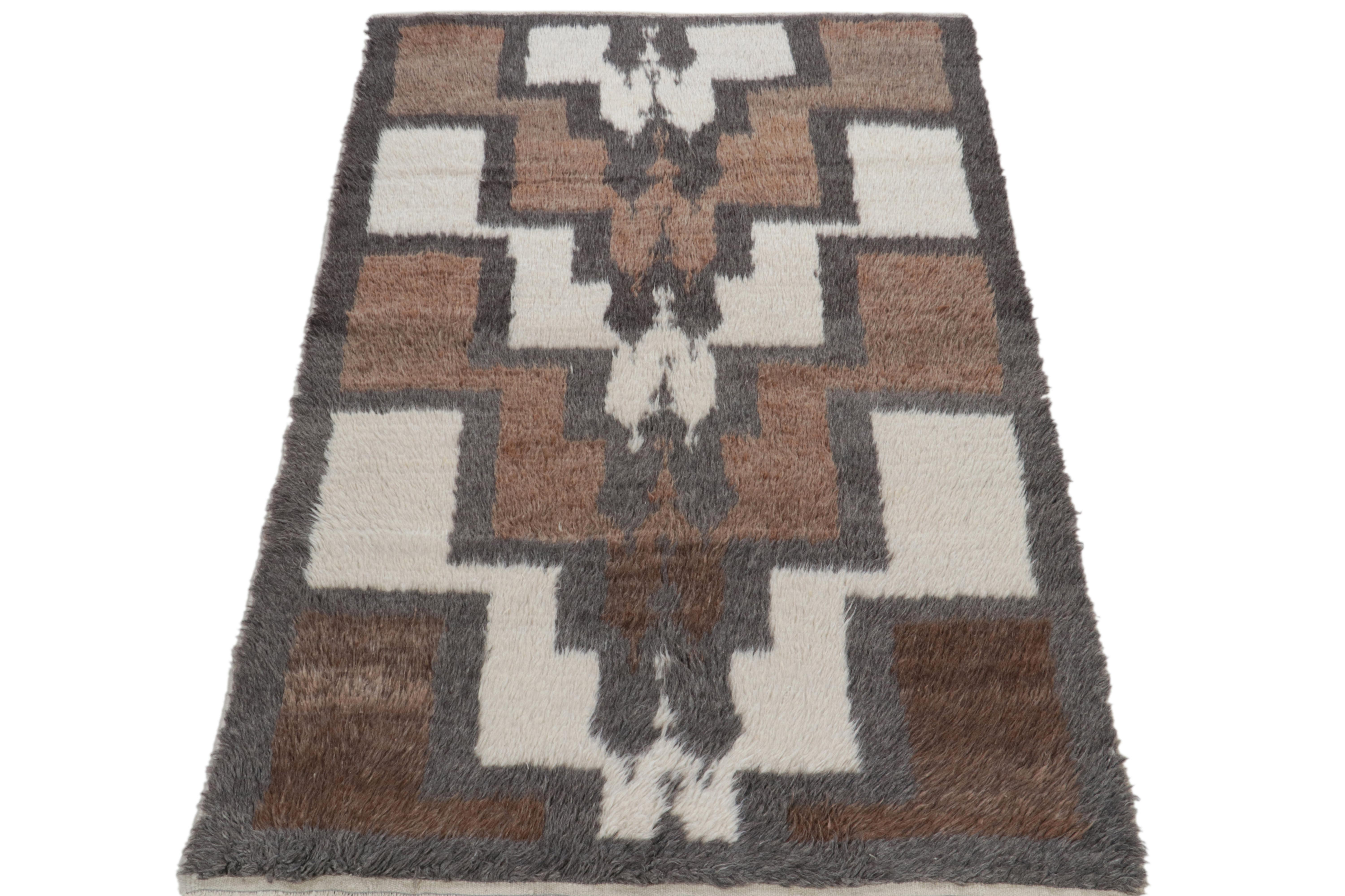 A 4x7 vintage Tulu tribal rug from Turkey entering Rug & Kilim’s Antique & Vintage collection. The piece is hand-knotted in a fine shag pile with high low texturability on the border for enhancing the appeal of the tribal geometric pattern of the