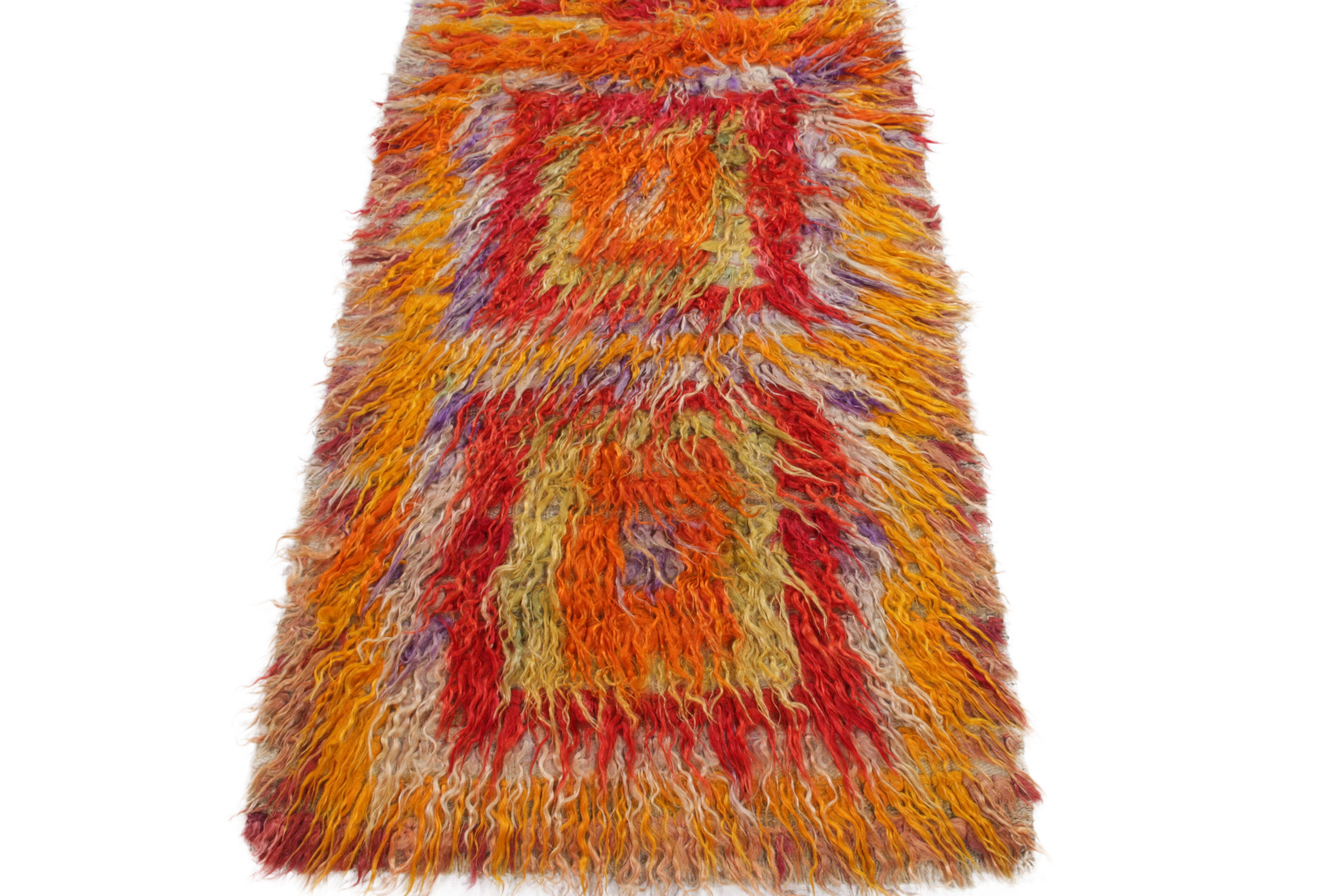 A 3x5 vintage Tulu rug from Turkey emanating exceptional mid-century aesthetics with high low texturability in a multicolor shag pile. 

Hand-knotted in lush wool, this rug further brings liveliness with a tribal geometric pattern in red, yellow,