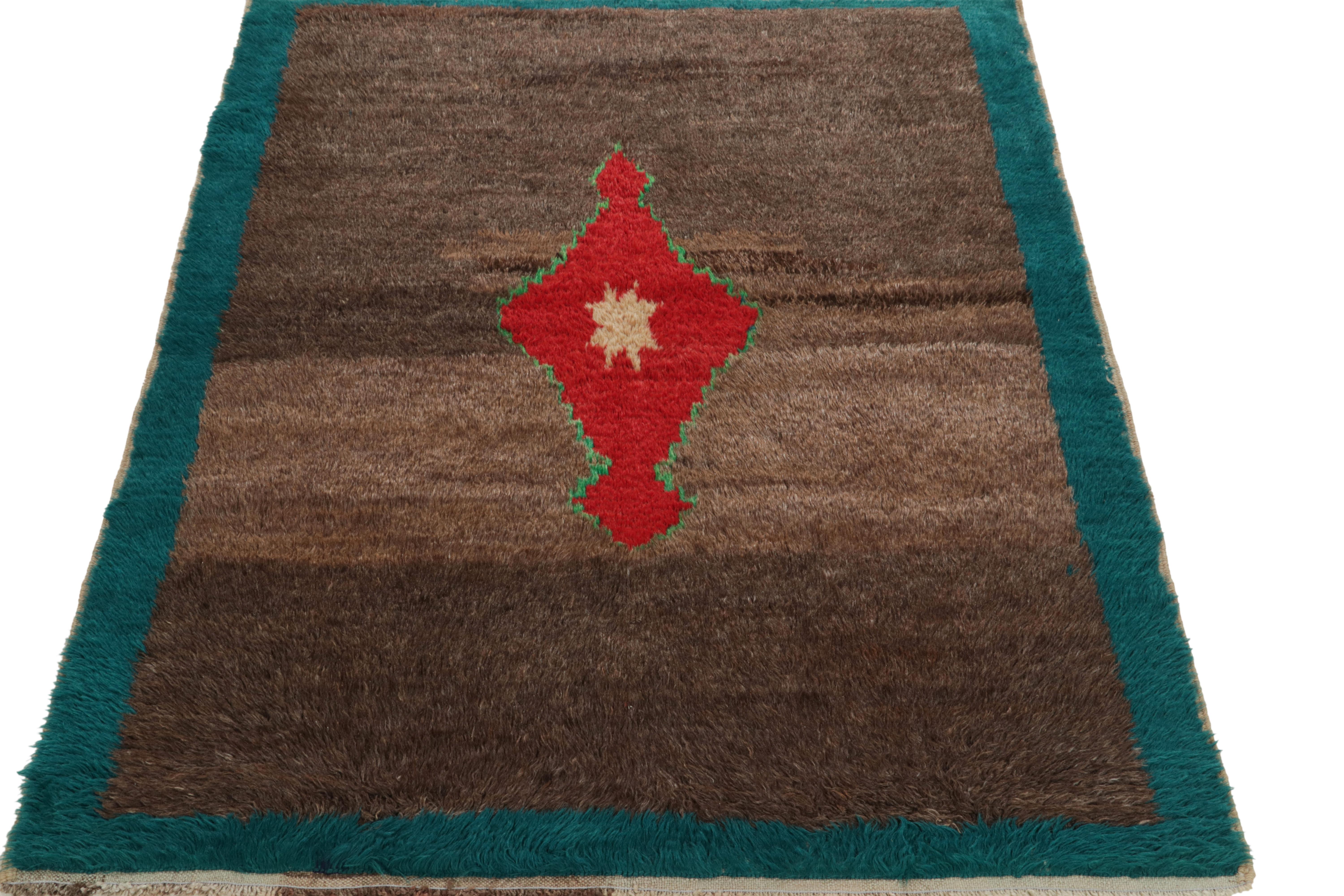 An impeccable display of Tulu sensibilities, a tastefully abrashed vintage rug featuring a striking red medallion with green & beige tints. Originating from Turkey circa 1950-1960, this 4x6 hand-knotted wool piece revels in a mature abrashed brown