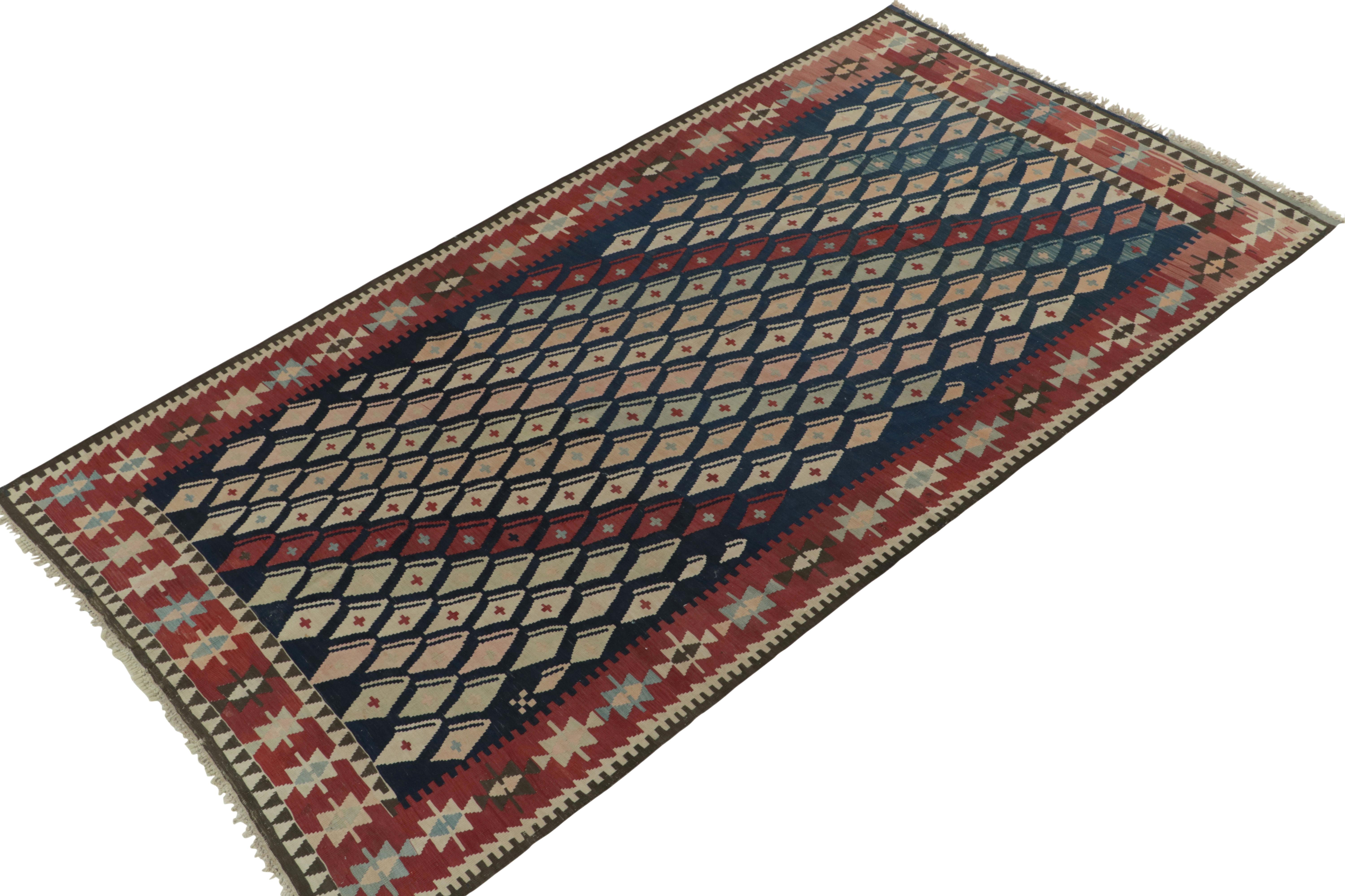 Hand-knotted in wool, a 5x10 vintage kilim rug entering Rug & Kilim’s coveted flat weave collection. This dedicated piece enjoys a dextrous tribal geometric pattern with a uniquely playful colorway of luscious red, blue, pink & beige —all
