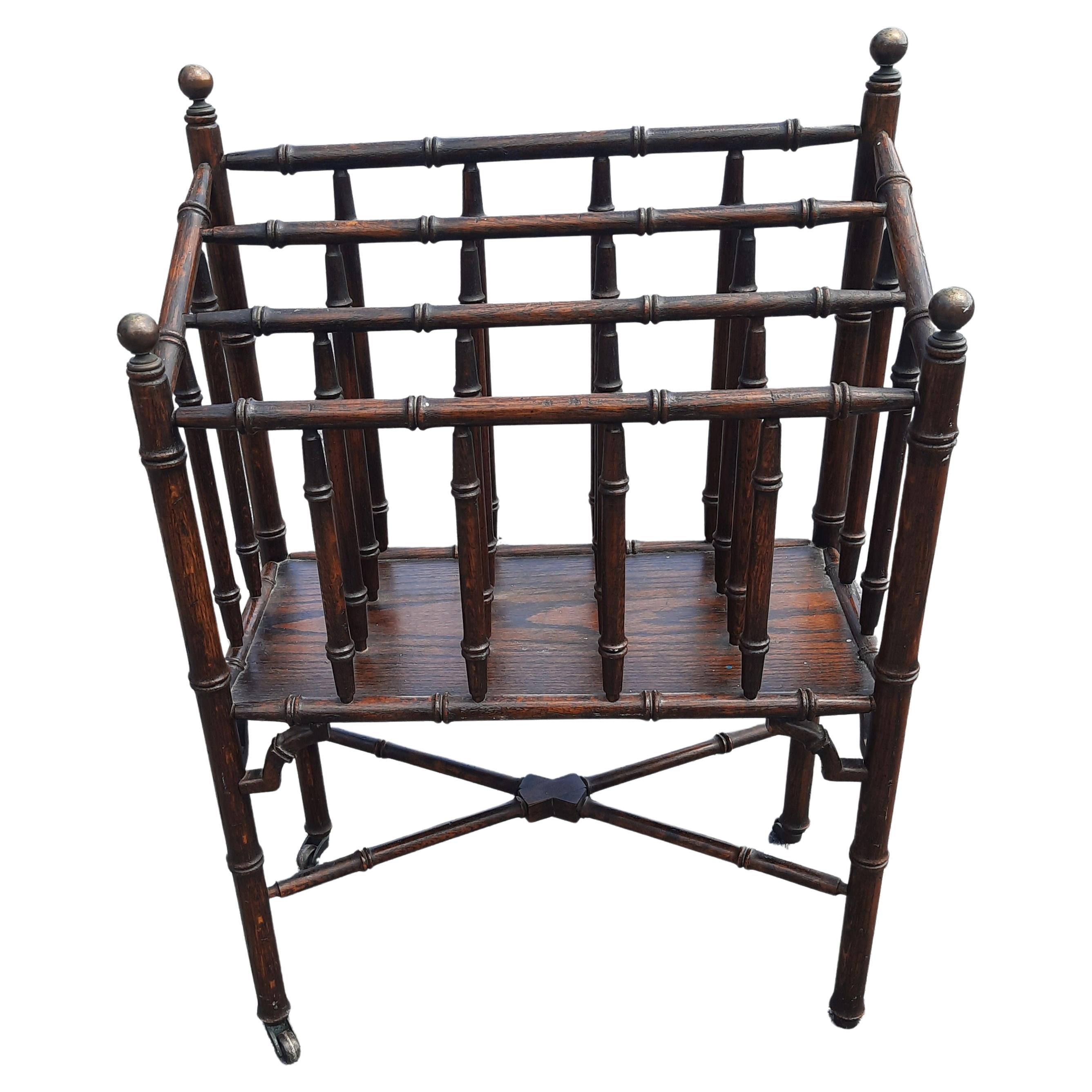 A rare Canterbury reviewer / magazine rack in faux bamboo turned oak with brass ball finials on original caster.
Very elegant and unique piece that will stand out in any decor. The piece has been very well maintained, show age patina, but no losses,