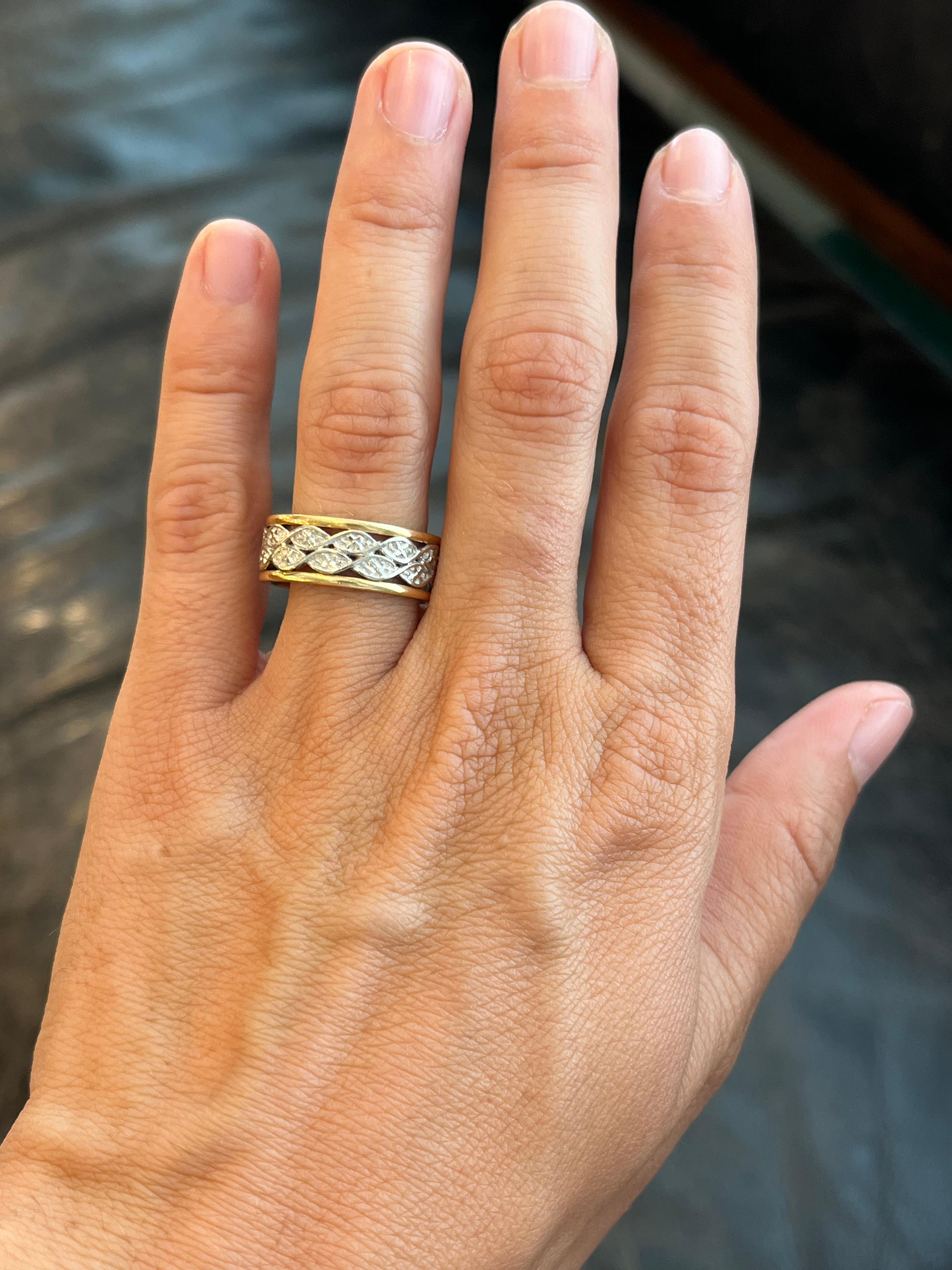 This 1950s vintage two-tone brilliant-engraved wedding band is one of many unique finds from our estate wedding ring collection at Bracken Jewelers in Santa Monica, California. The combination of yellow gold edges with white gold center bands gives