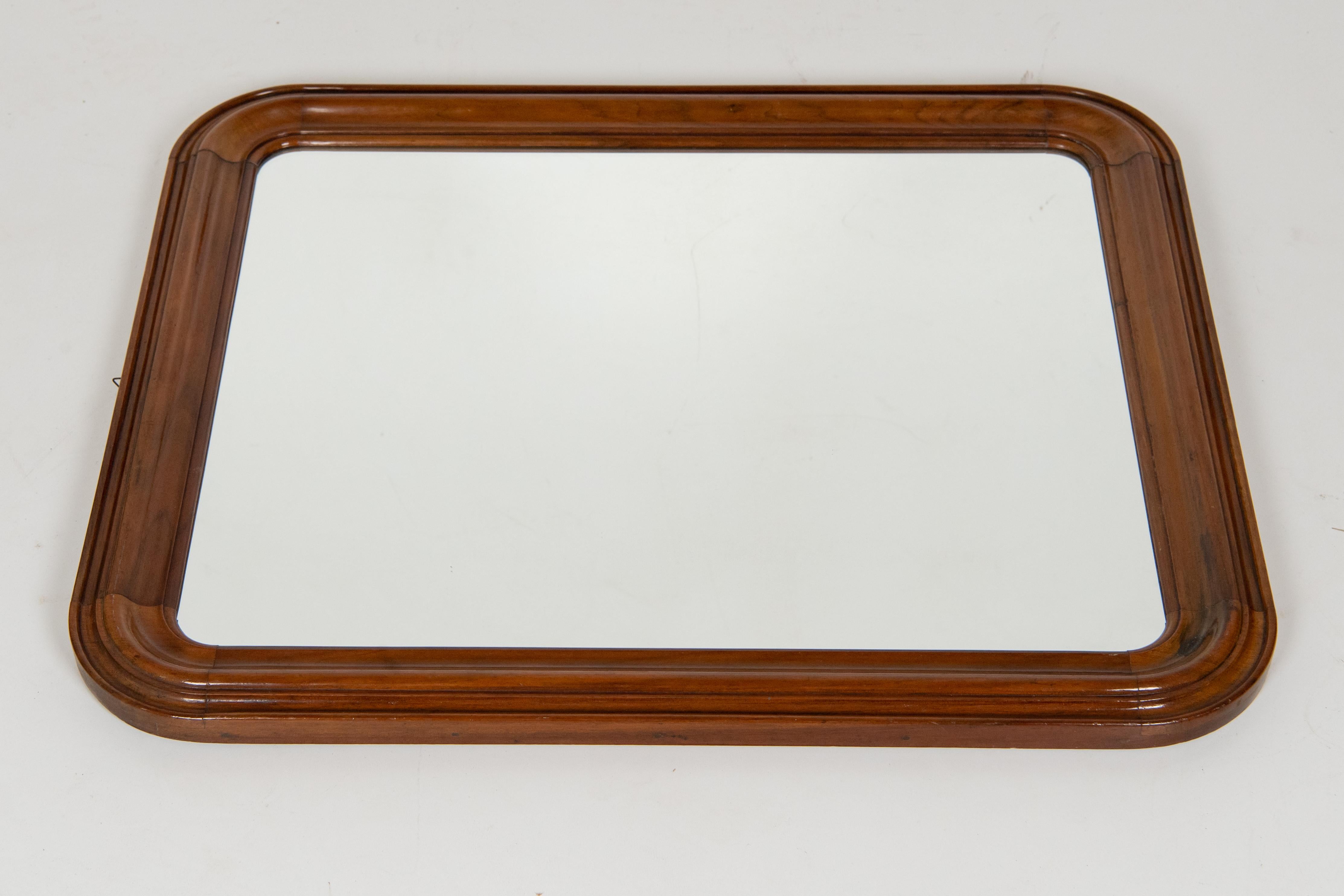 Elegant vintage wall mirror with carved solid hickory frame. Glass has been replaced meanwhile frame has been repaired and wood polished. In really good conditions with only few signs of time.