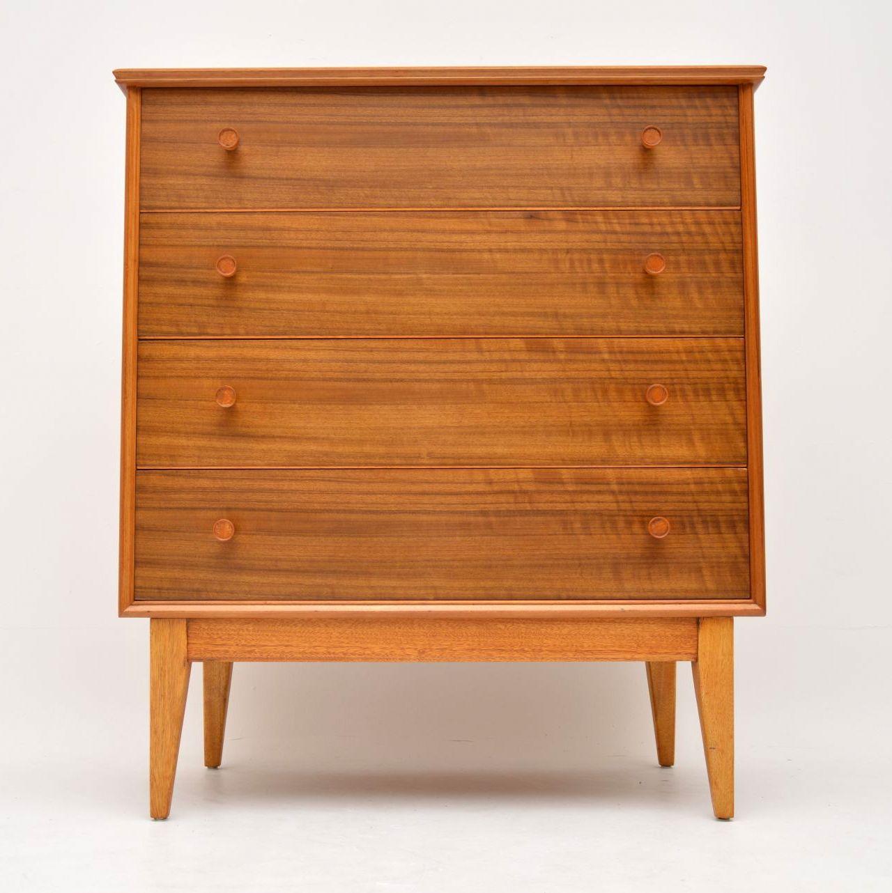 A smart, stylish and extremely well made vintage chest of drawers in walnut by the high end manufacturer Alfred Cox. This dates from the 1950s-1960s, we have had it completely stripped and re-polished to a very high standard, the condition is superb
