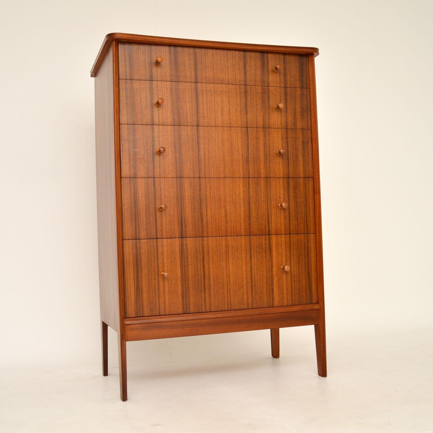 A stylish and very practical large chest of drawers in walnut. This was designed by Peter Hayward for Vanson, it was made in England and dates from the 1950-60’s.

It is of excellent quality, is beautifully styled and has lots of storage space in