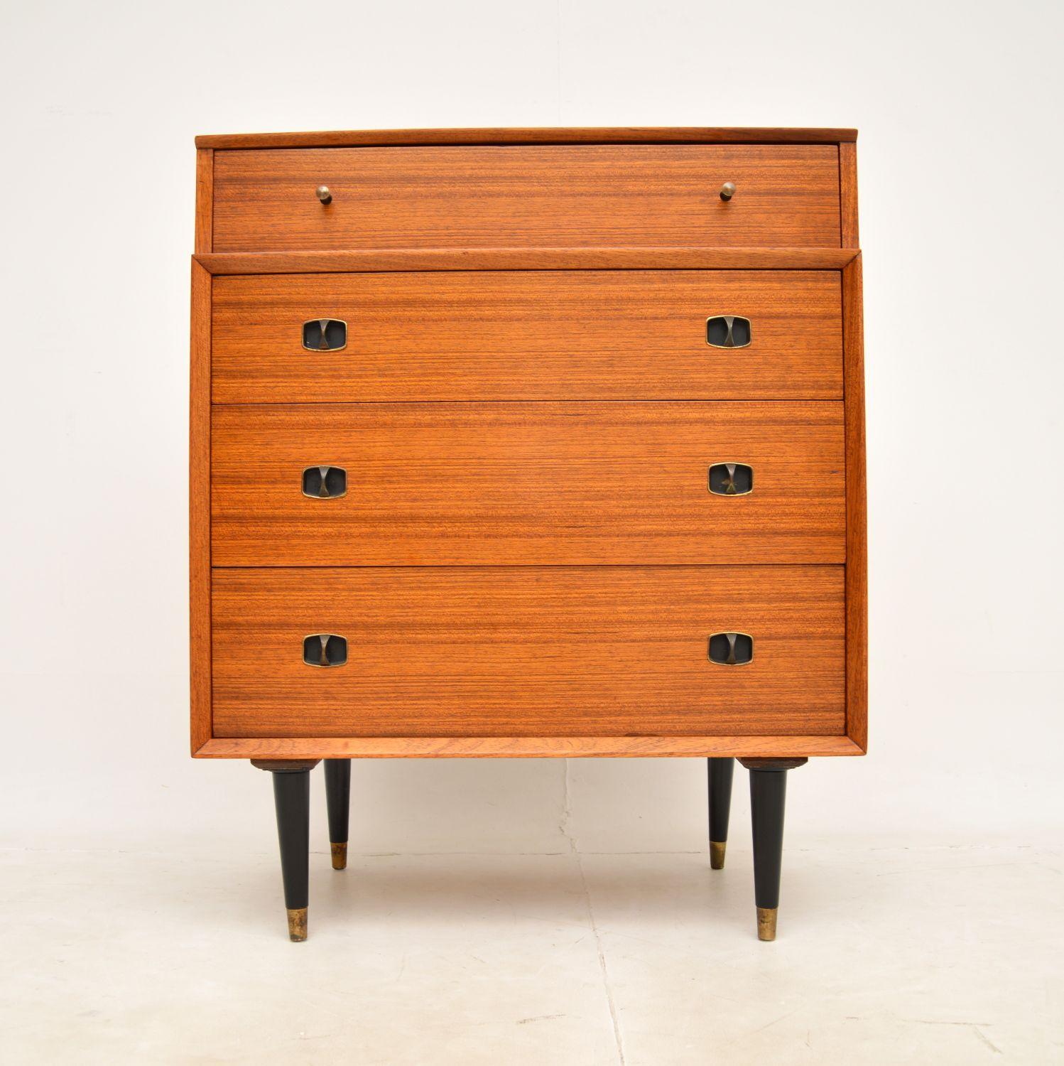 A very stylish and useful vintage walnut chest of drawers. This was made in England, it dates from around the 1950-60’s.

This is of great quality, it is beautifully designed with lots of storage space. It sits on ebonised tapered legs with brass