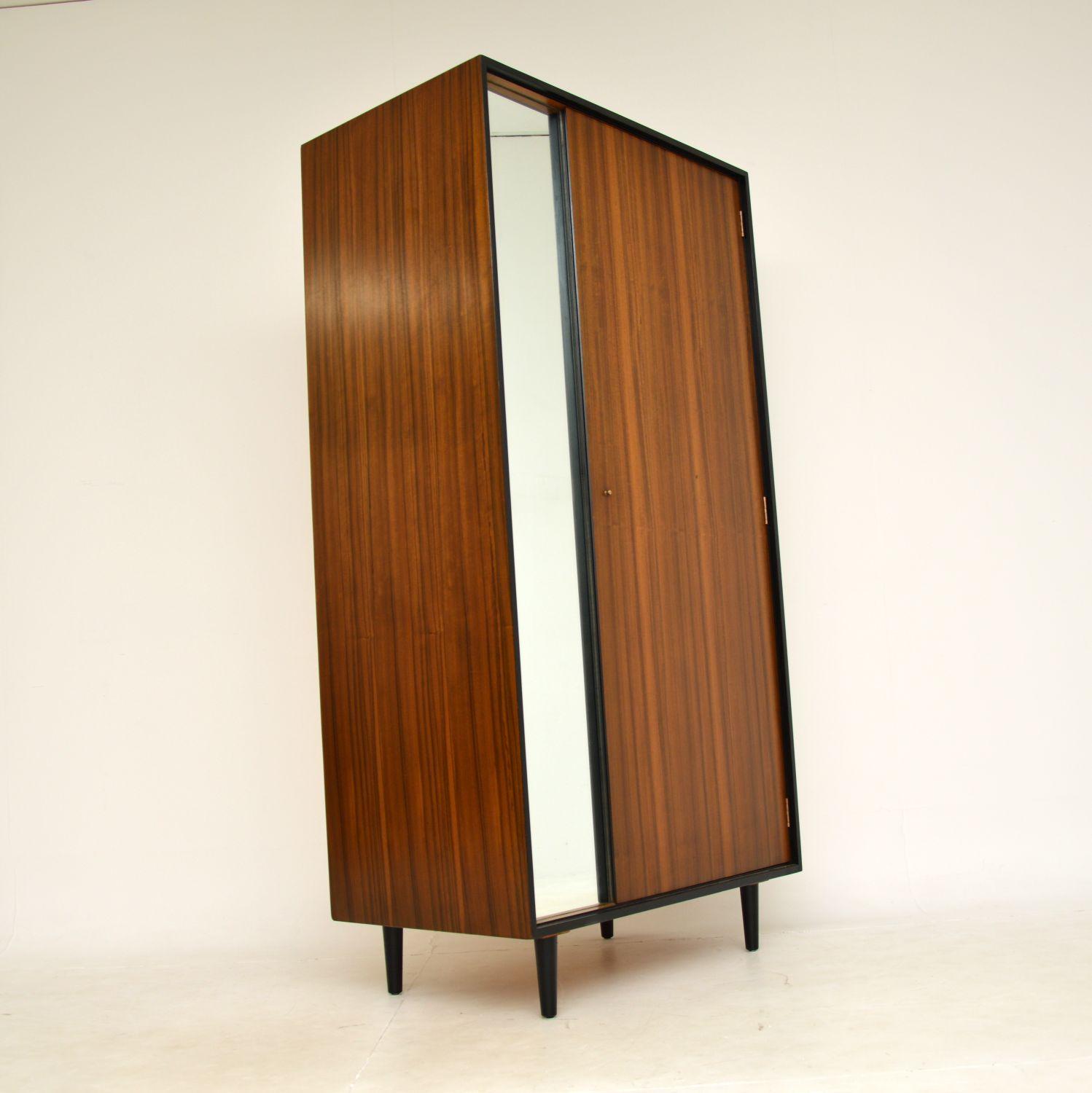 A beautifully designed and extremely well made vintage wardrobe in walnut. This was made in England, and dates from the 1950-1960s.

It was designed by John & Sylvia Reid for Stag’s C Range of furniture. The quality is superb, there is lots of