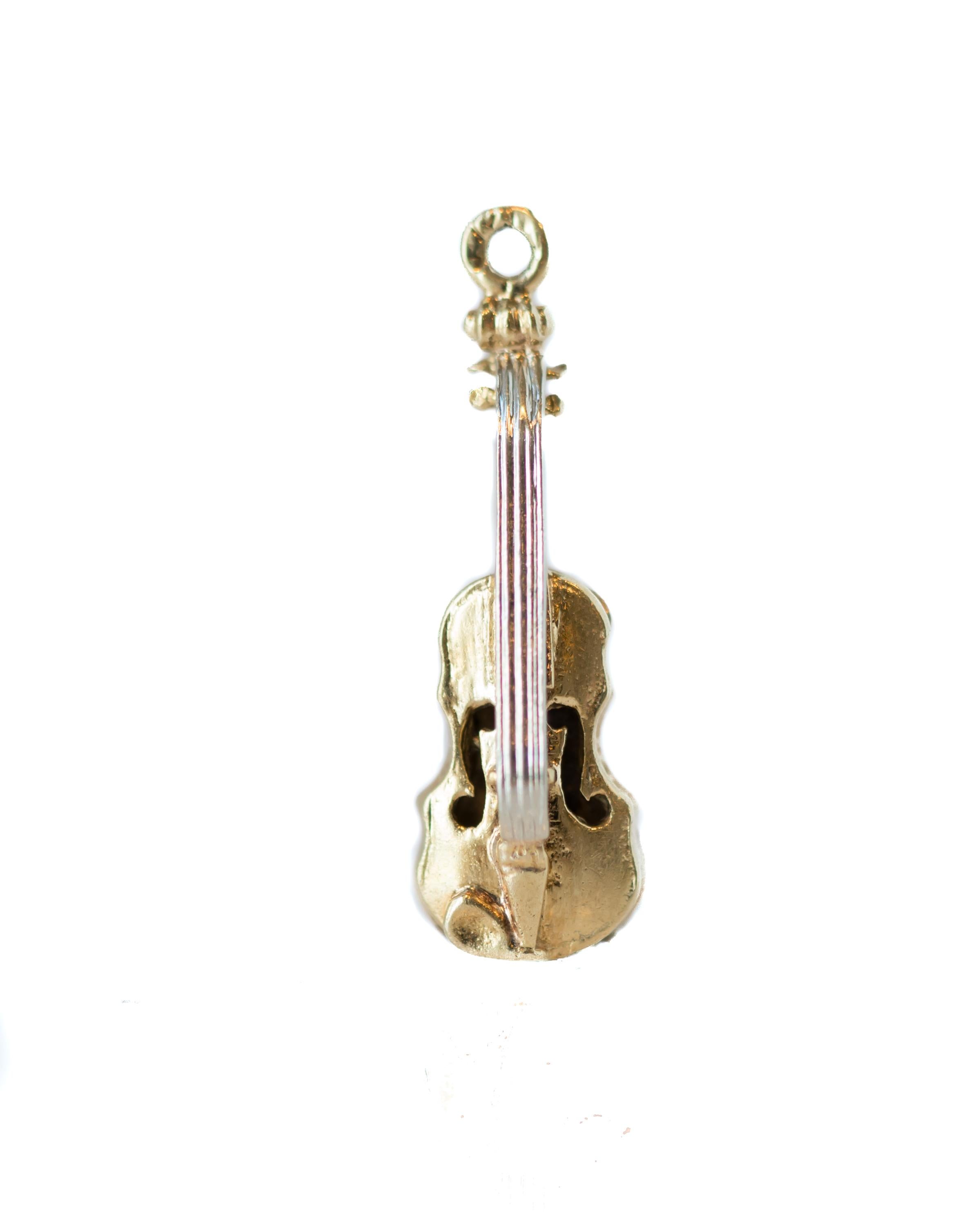 1950s Retro Violin, Viola Pendant or Charm in Shining 14k Yellow Gold

Features:
Tiny Stringed Violin 
Sleek, Detailed Design
High Polish 14k Yellow Gold
Sturdy Bail 
Measures 20 x 7 millimeters 

Charm Details:
Dimensions: 20 x 7 millimeters
Metal: