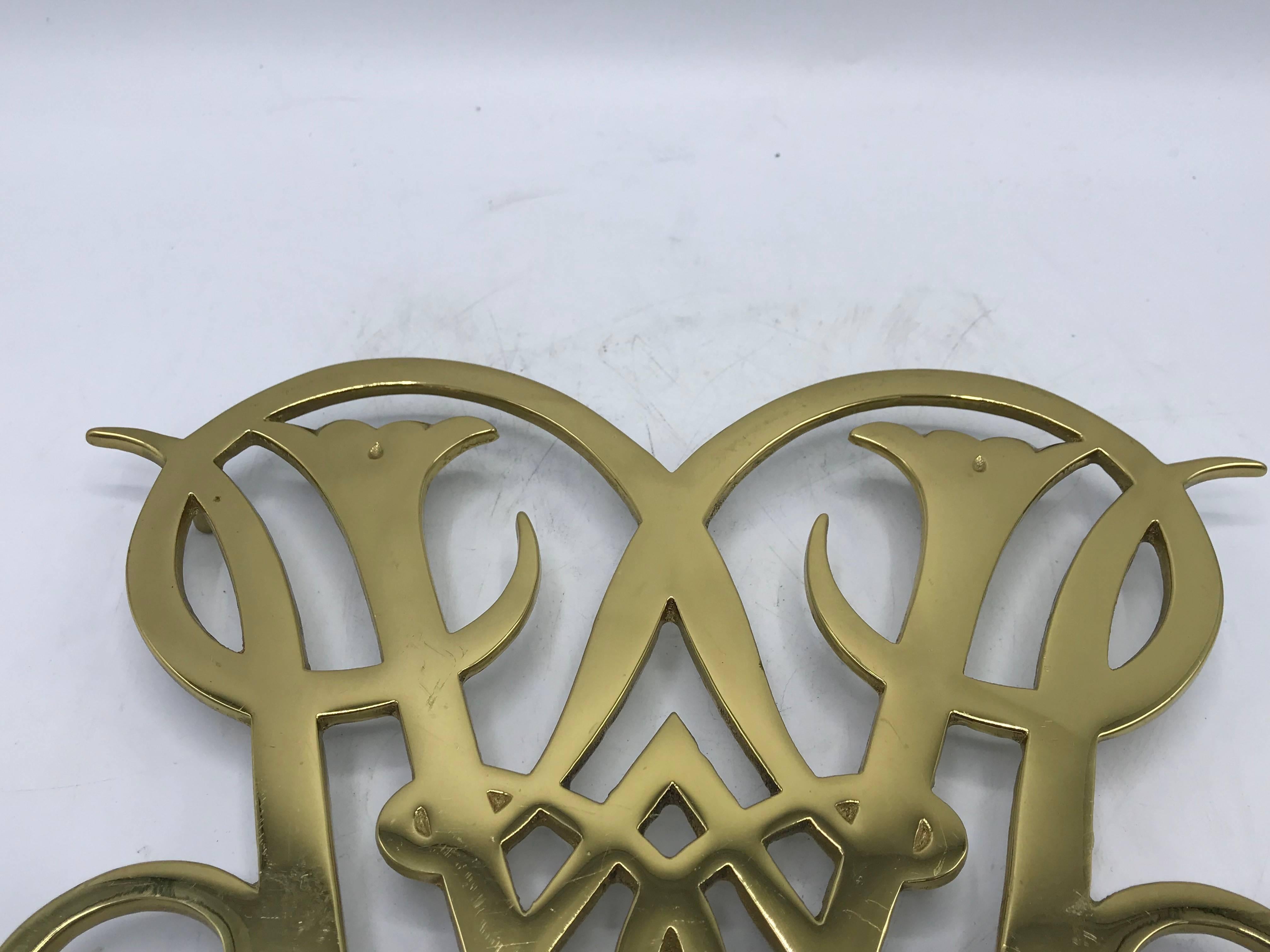 Offered is an iconic and traditional, 1950s Virginia Metalcrafters solid-brass, Queen Ann Cypher of Williamsburg trivet. Would be beautiful for intended use, plant stand, or as tabletop decor. Marked on backside with Virginia Metalcrafters signature