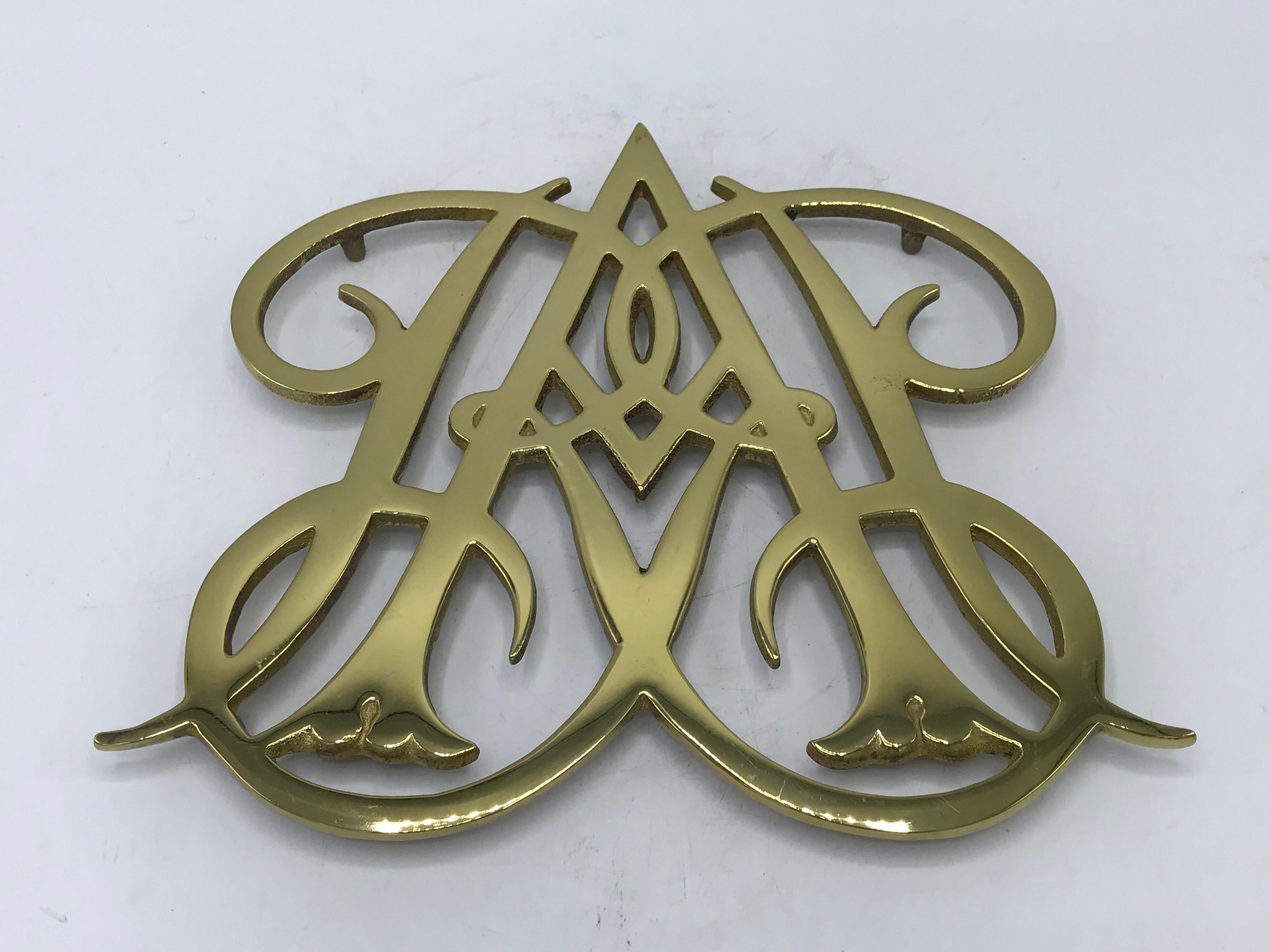 Offered is an iconic and traditional, Virginia Metalcrafters solid-brass, 'Queen Ann Cypher of Williamsburg' trivet, circa 1950s. Would be beautiful for intended use, plant stand, or as tabletop decor. Marked on backside with Virginia Metalcrafters