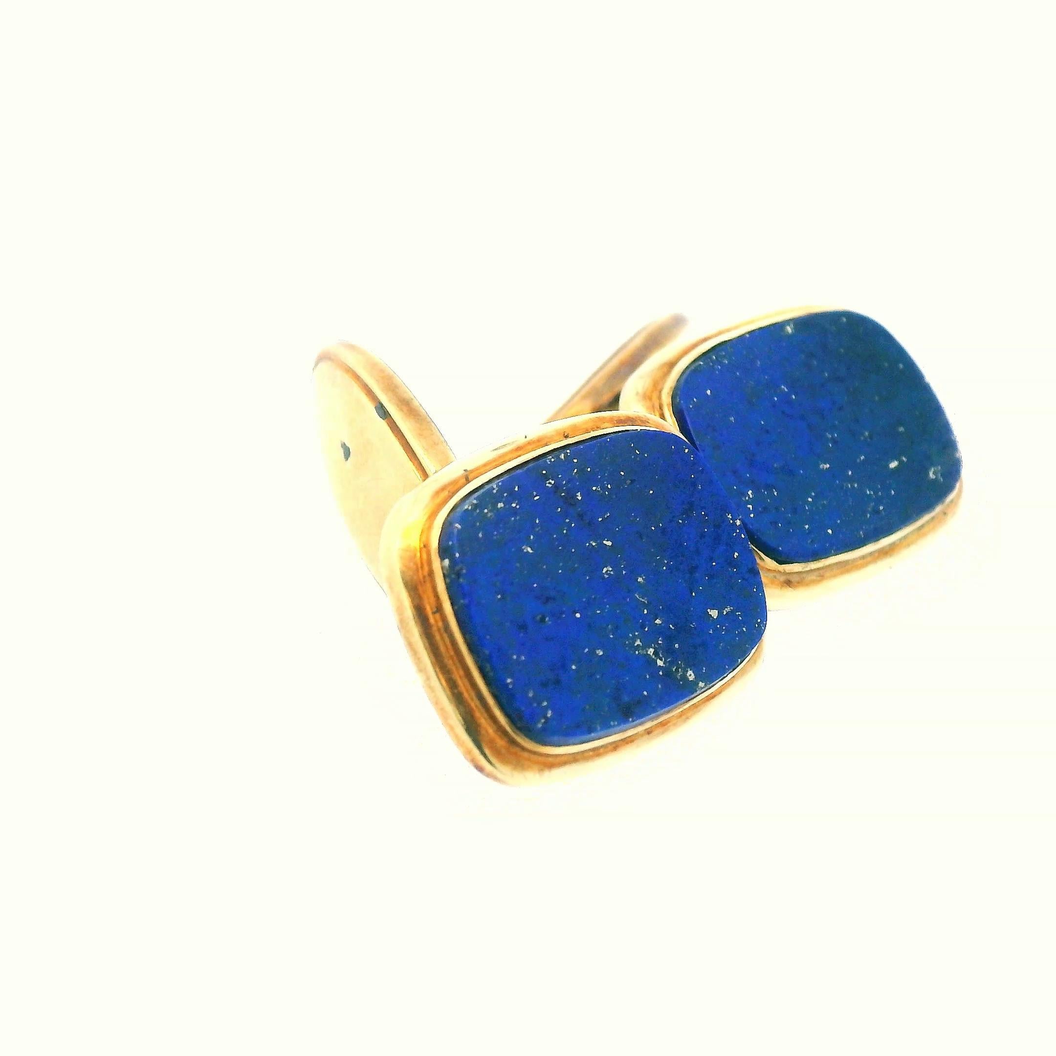 This stunning pair of cufflinks from West Germany were made with 14k yellow gold and a rich blue lapis. These cufflinks embody sophistication and luxury. Each cufflinks features polished 14k yellow gold. The rich hie of gold creates a striking