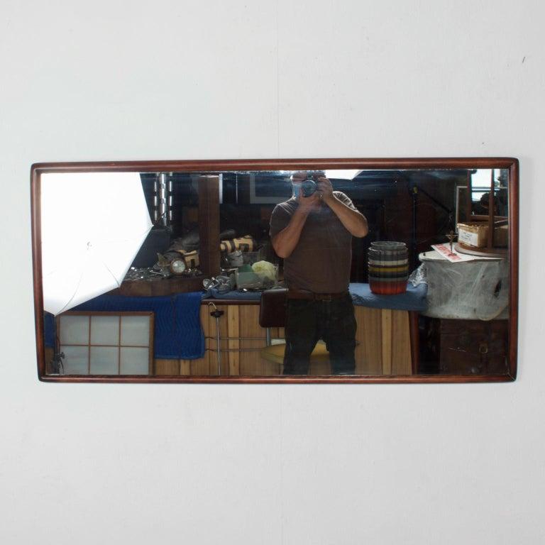 
1950s Wall Mirror designed by T. H. Robsjohn-Gibbings, 
Wood Framed Mirror for Widdicomb
24H x 51 x 1.5 Thick
Original vintage preowned condition.
Refer to images provided.
Local delivery is available.
