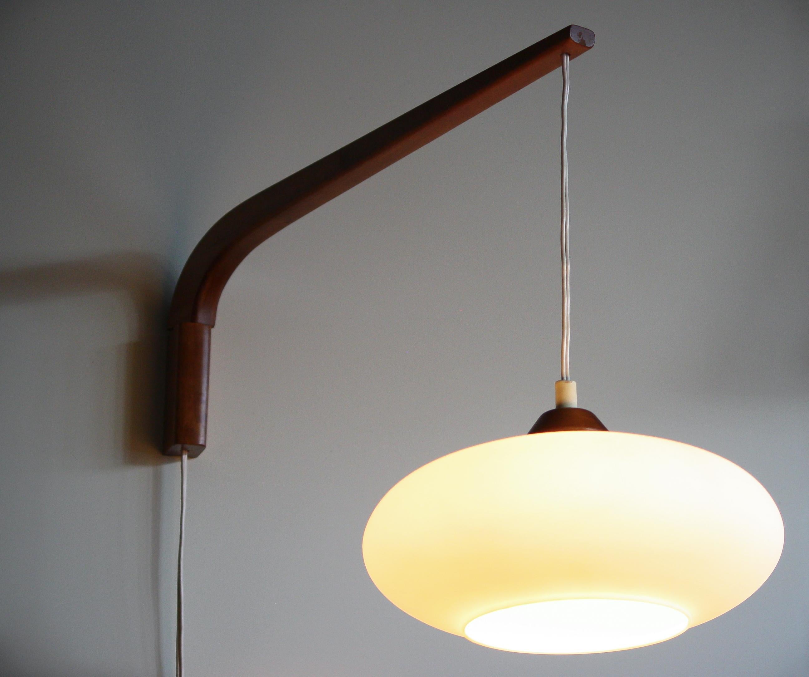 Beautiful wall pendant designed by Uno & Östen Kristiansson for Luxus Sweden.
It is made of teak with opaline glass.
The lamp is in a wonderful condition.
Period 1950s
Dimensions: H 44 cm, ø.28 cm