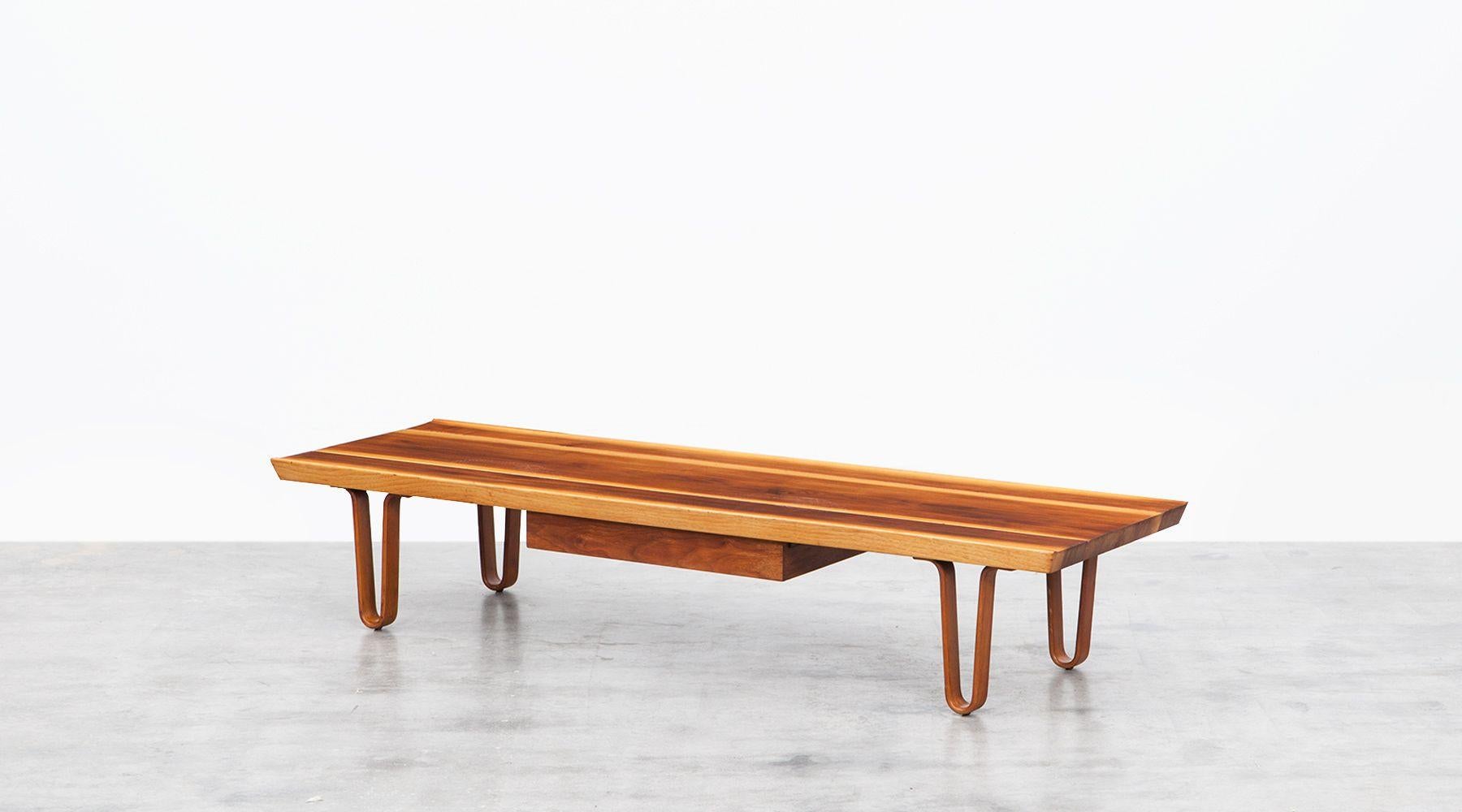 Edward Wormley bench made out of solid walnut wood with single drawer can also be used as a coffee table. The remarkable feet are plywood. Manufactured by Dunbar. We have two more examples in stock.

This design at Indiana based company Dunbar
