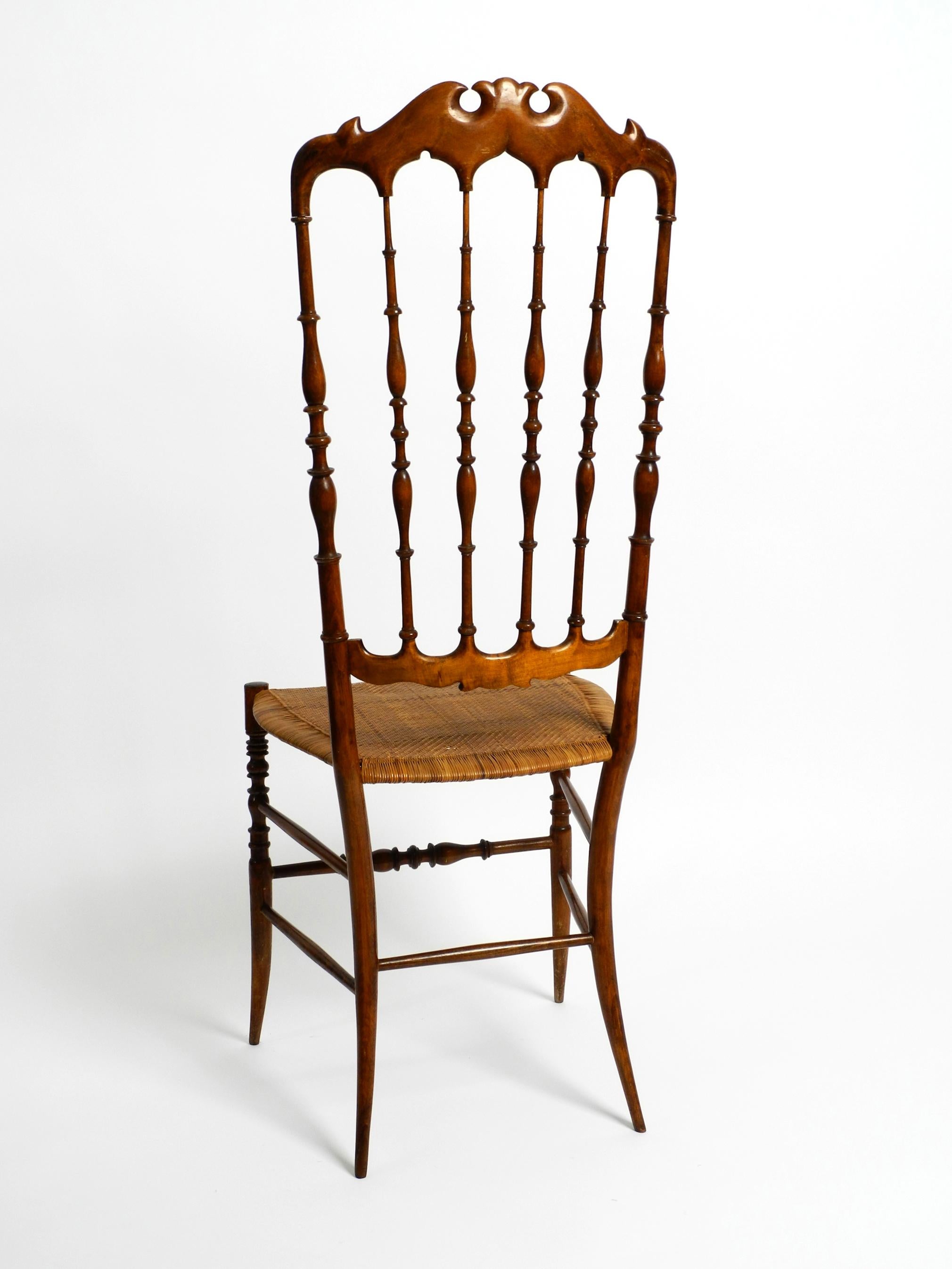 Extremely rare Mid Century Italian walnut Chiavari chair with wicker seat and high backrest.
Related to the design of Giuseppe Gaetano Descalzi.
Descalzi (1767-1855) was a Genoese furniture maker best known for inventing the Chiavari chair. He was