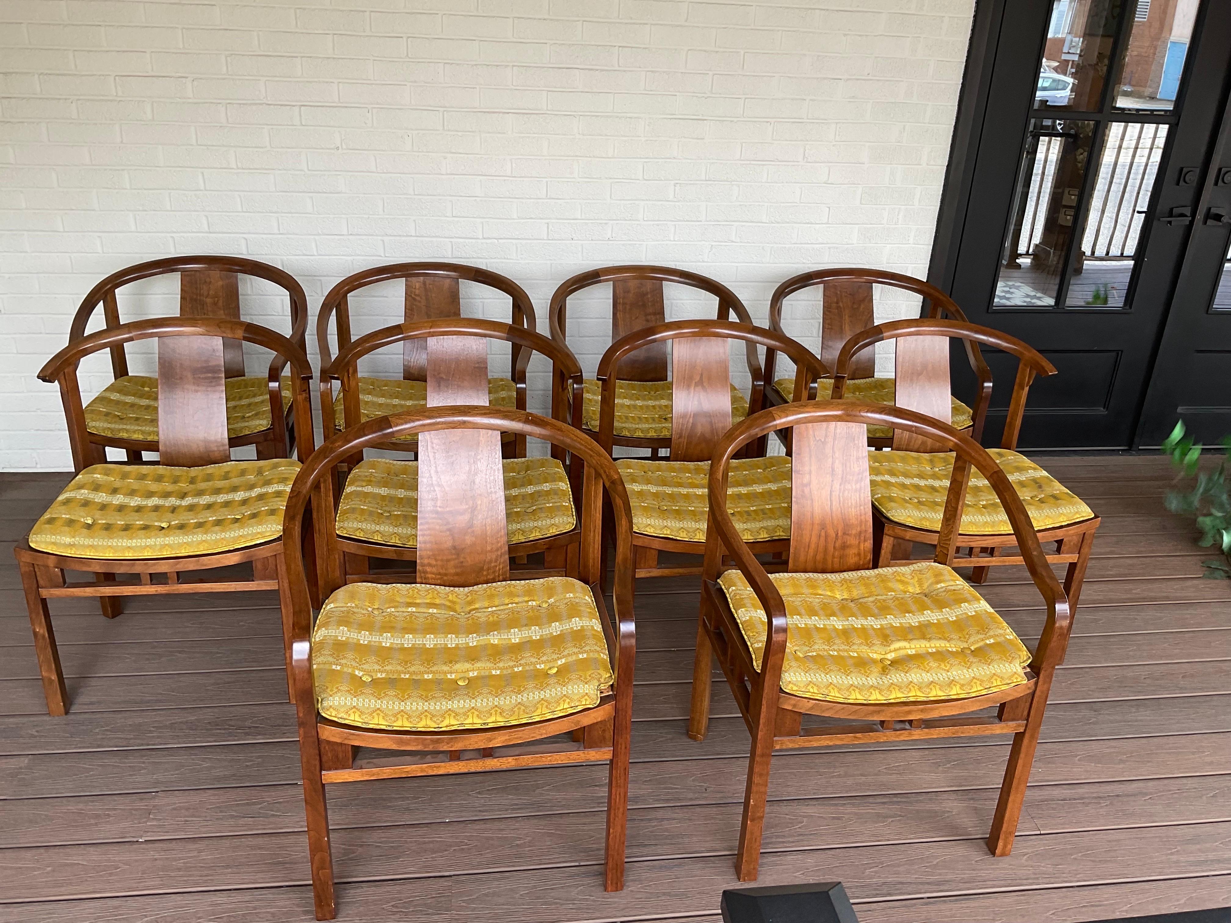 Arguably one of the finest examples in existence boasting the original finish and spectacular upholstered seat pads over cane seats. These are Rare and extraordinary in their presence and condition. 4 side chairs and 6 arm chairs alternate around