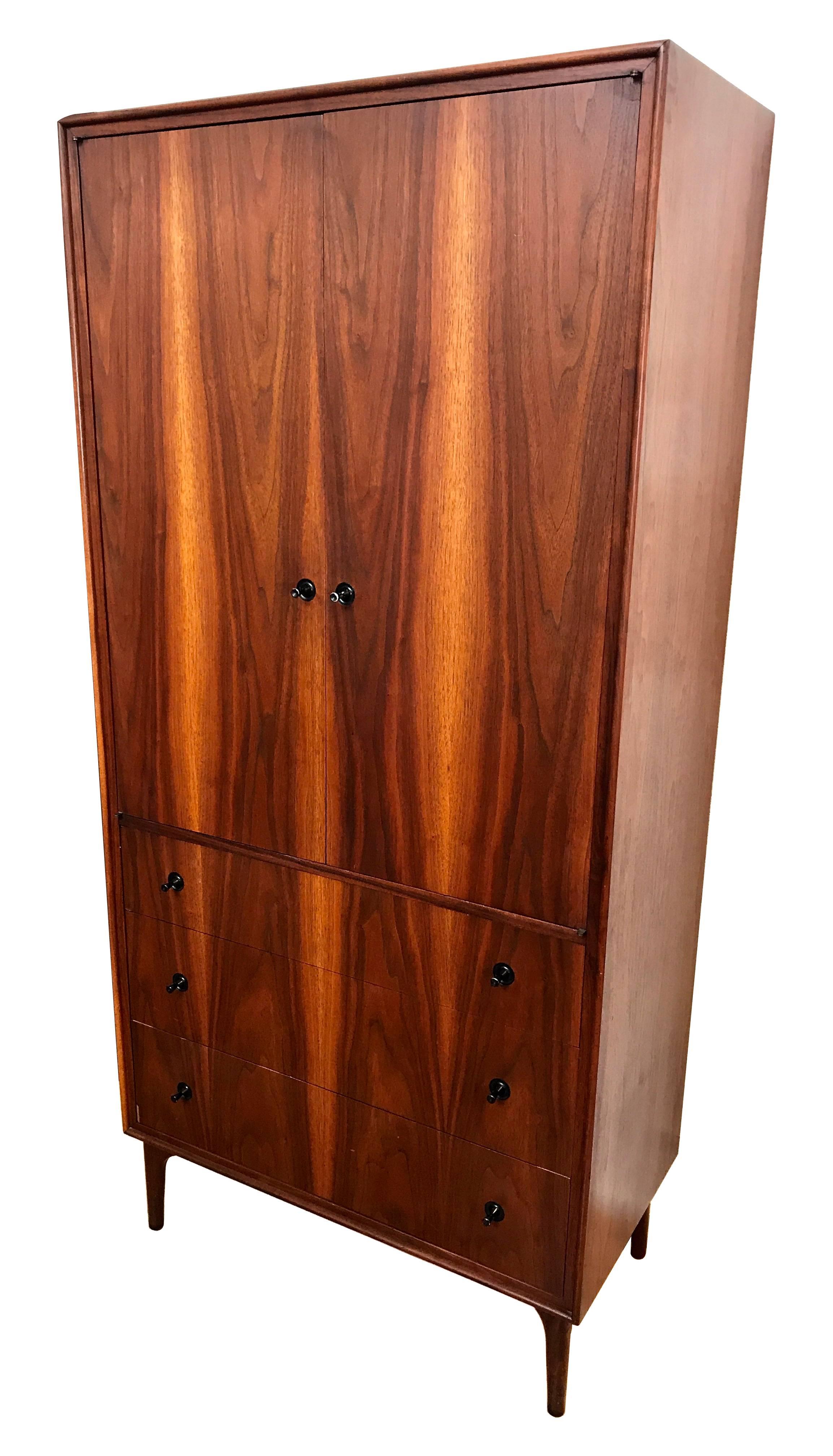 1950s tall walnut gentleman's dresser designed by John Kapel for Glenn of California. The dresser top opens to reveal shelving, with three small drawers (one drawer is missing) and a locking drawer with key, as well as a mirror that swings out with